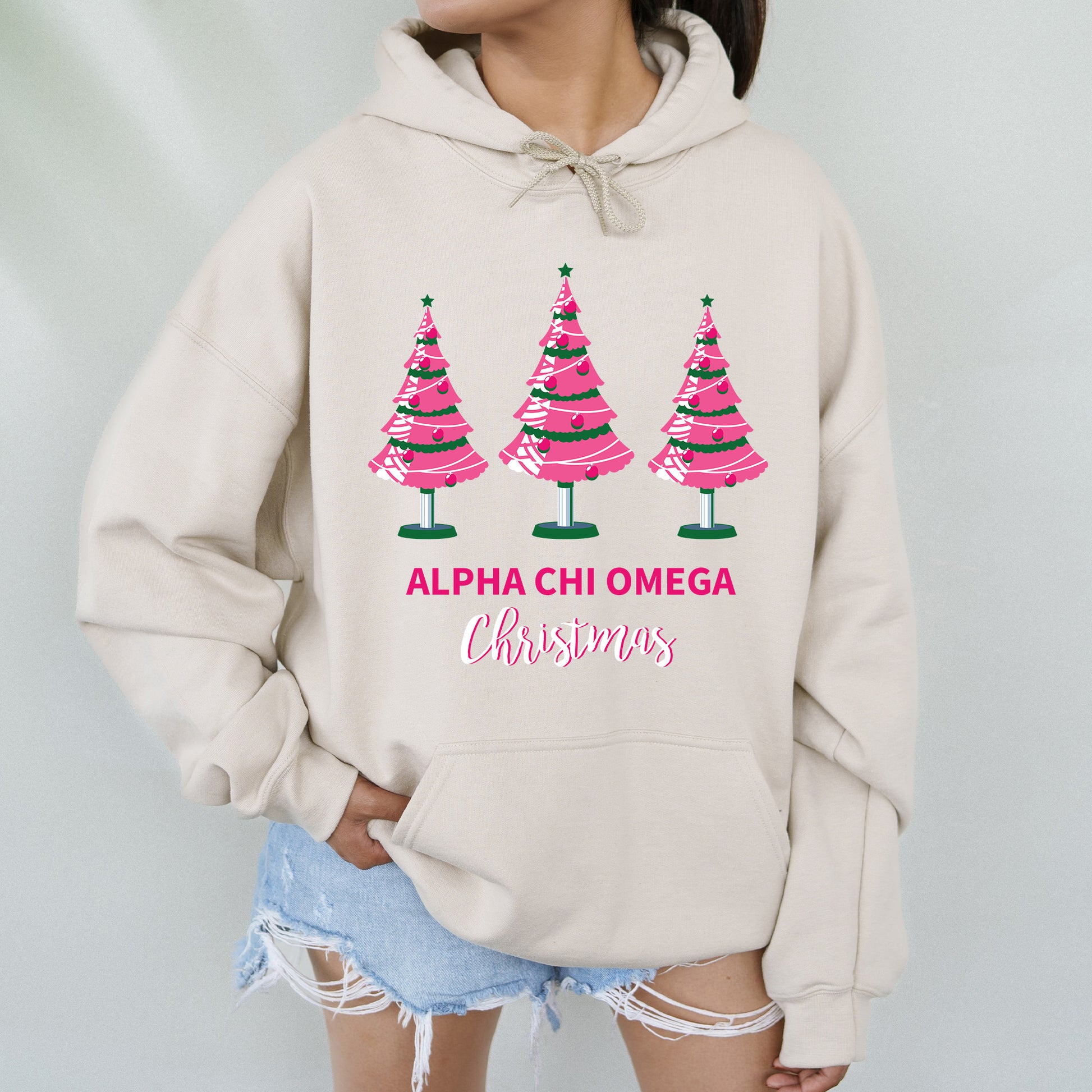 a woman wearing a sweatshirt with christmas trees on it