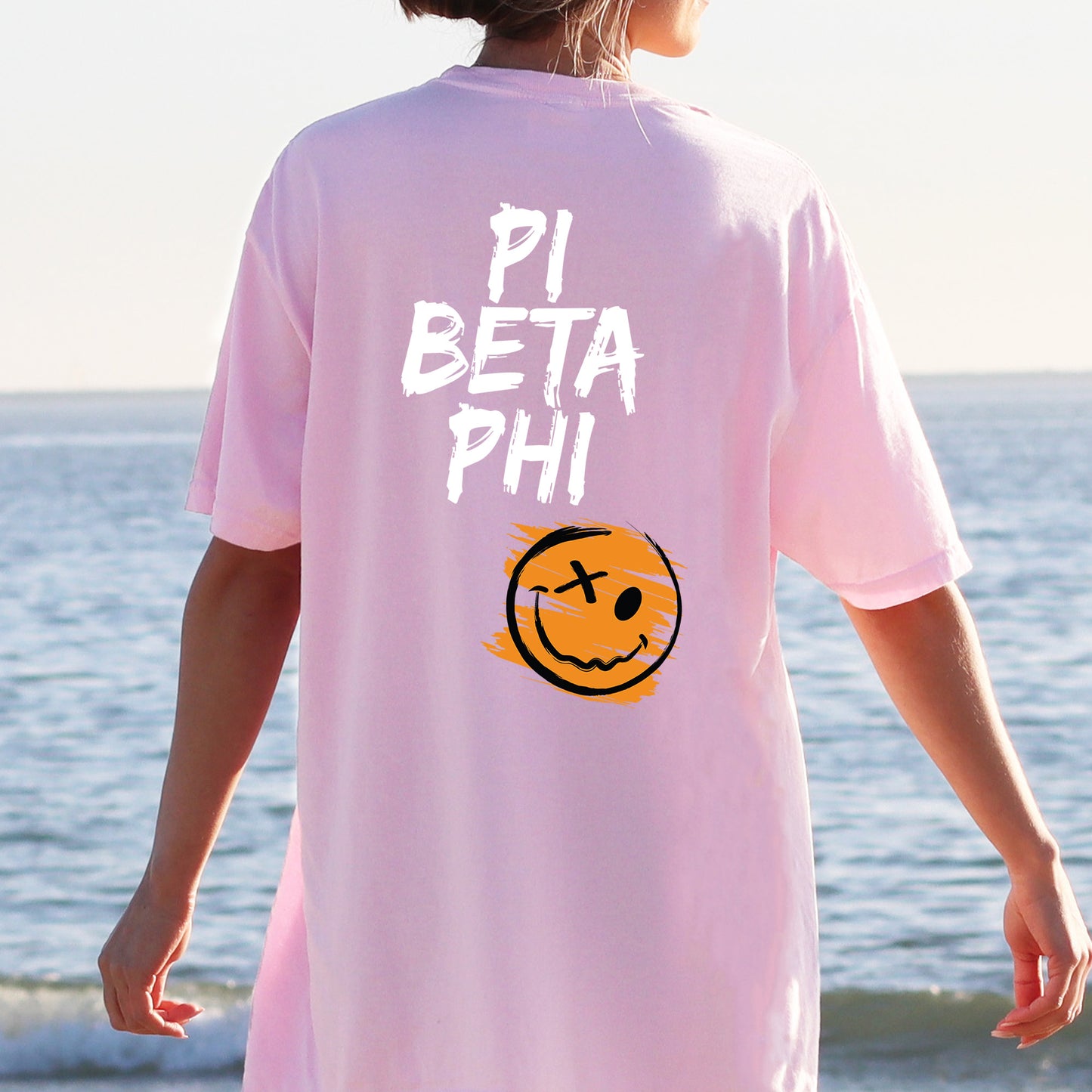 a person wearing a pink shirt with a smiley face on it