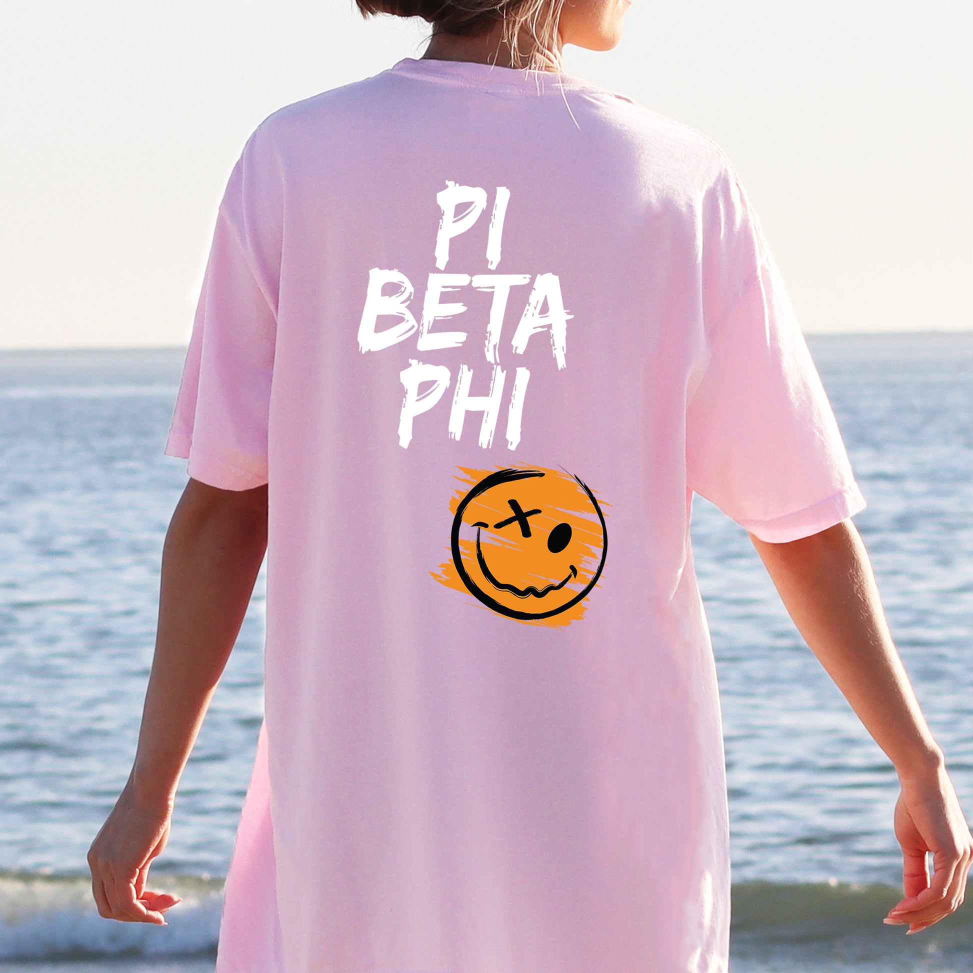 a person wearing a pink shirt with a smiley face on it