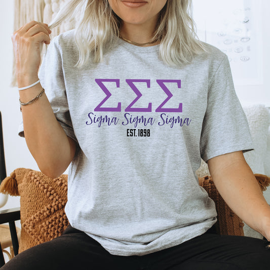 a woman sitting on a chair wearing a tshirt