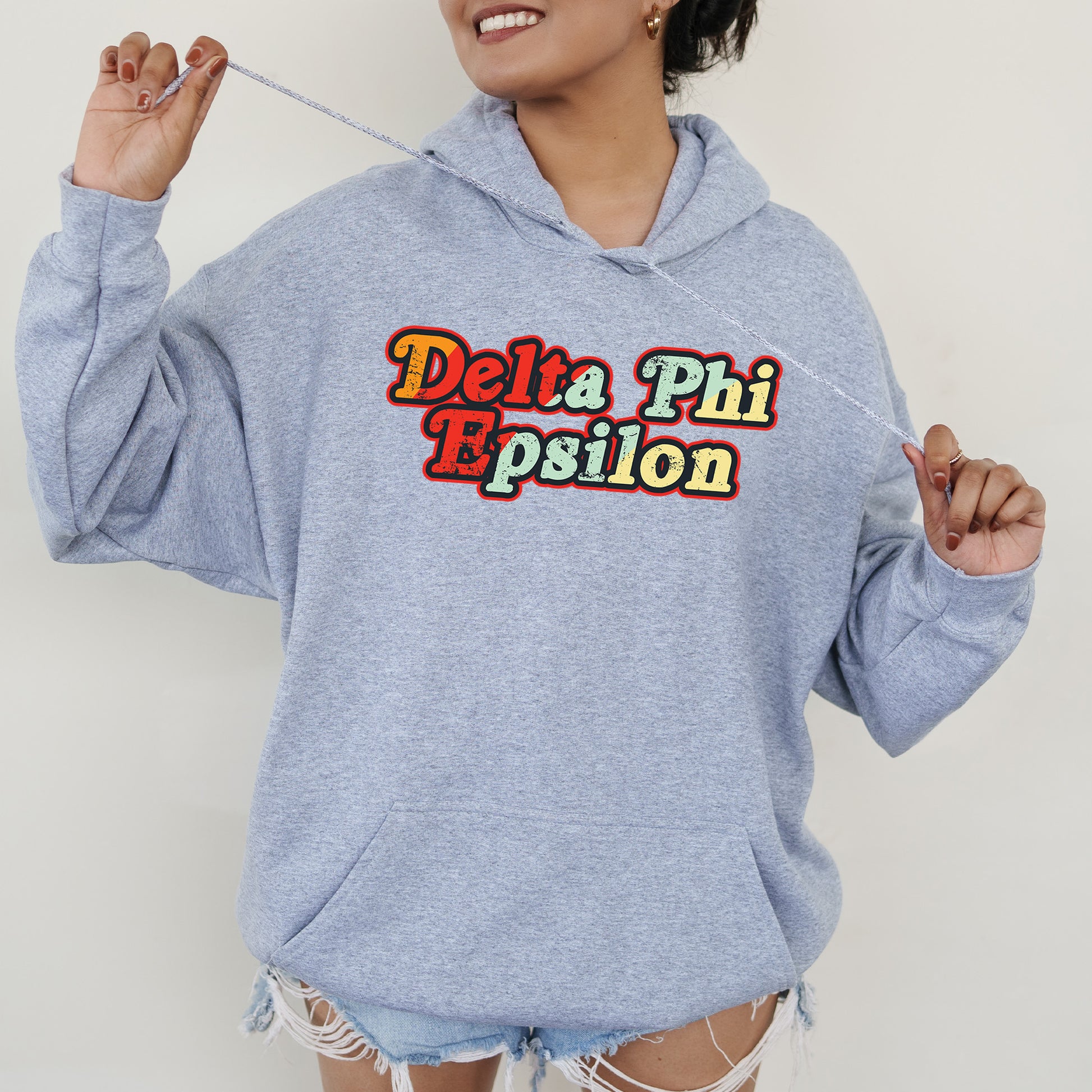 a woman in a blue hoodie holding a toothbrush