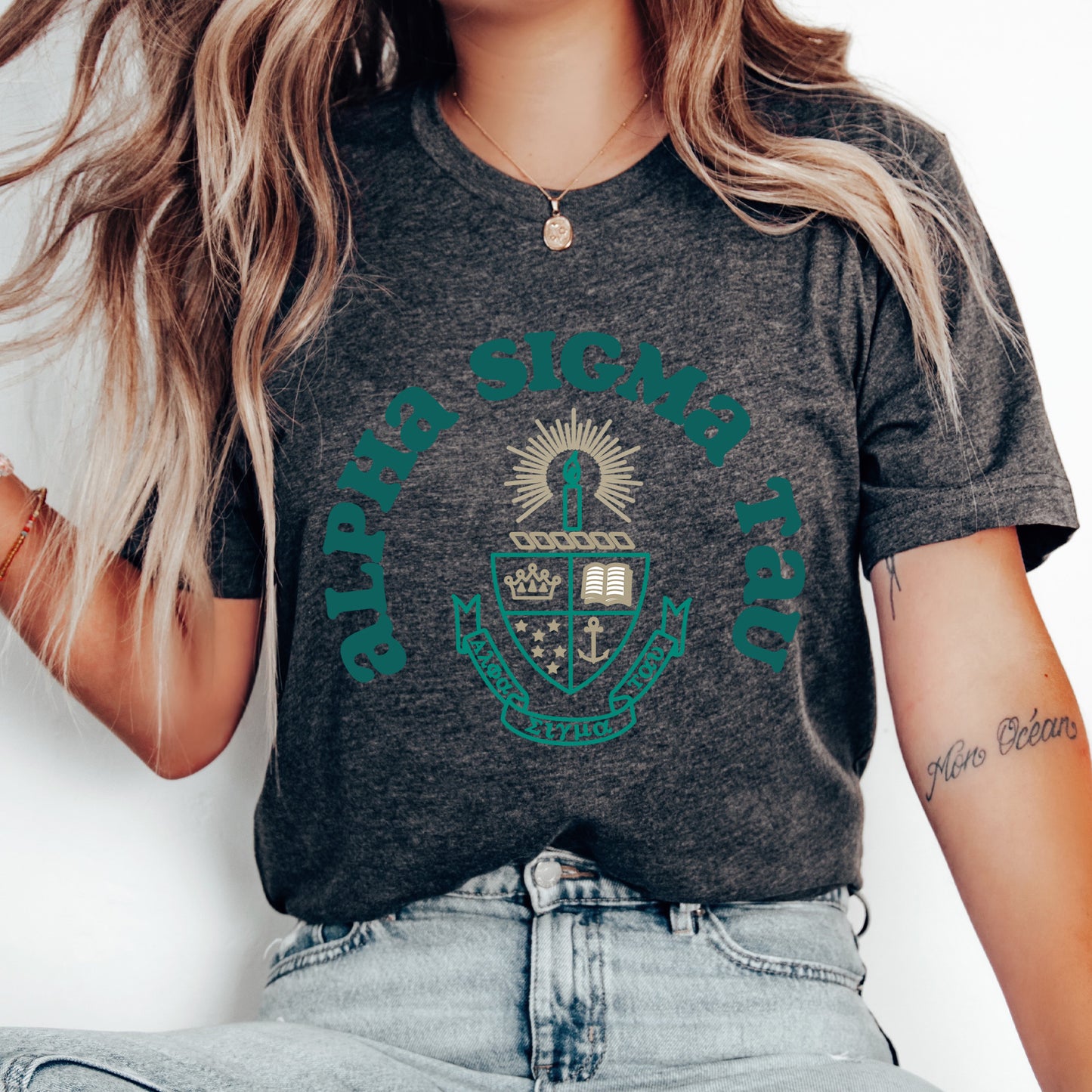 a woman wearing a t - shirt with a crest on it