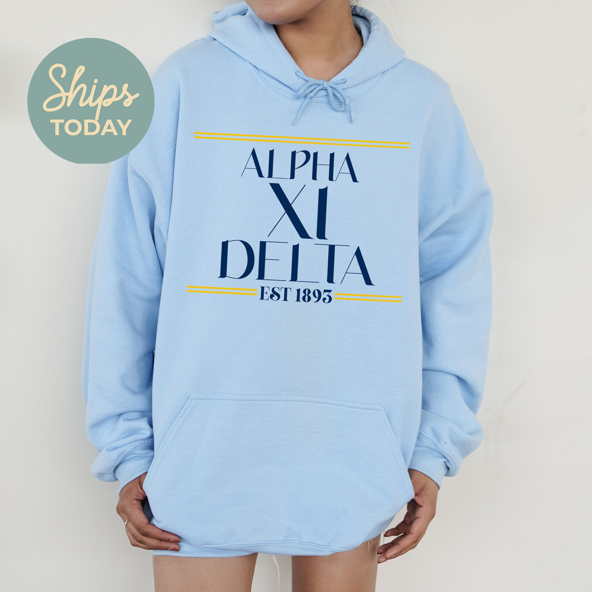 a person wearing a blue hoodie with the words alpha xi delta printed on it