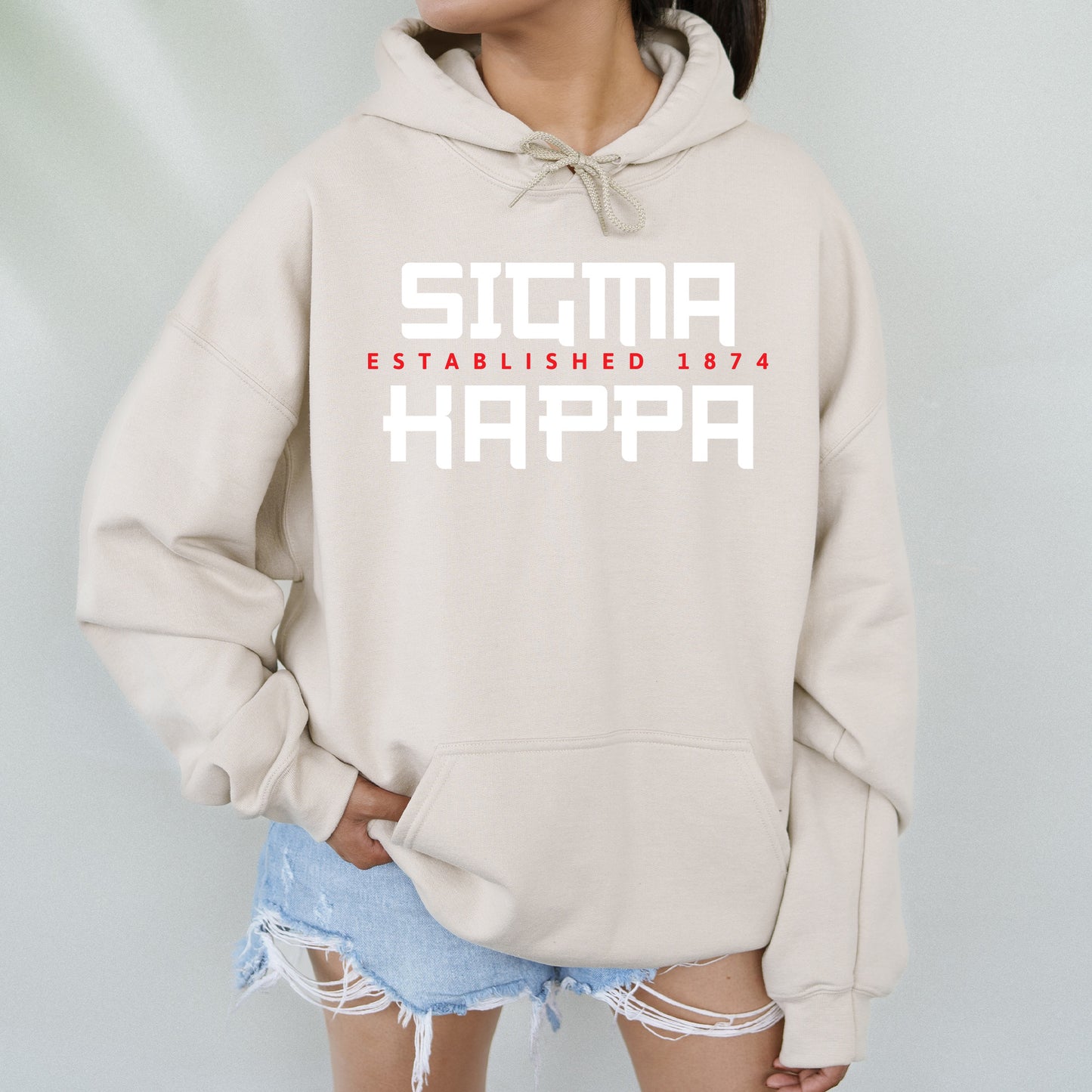 a woman wearing a sweatshirt with the words stigma established in red and white