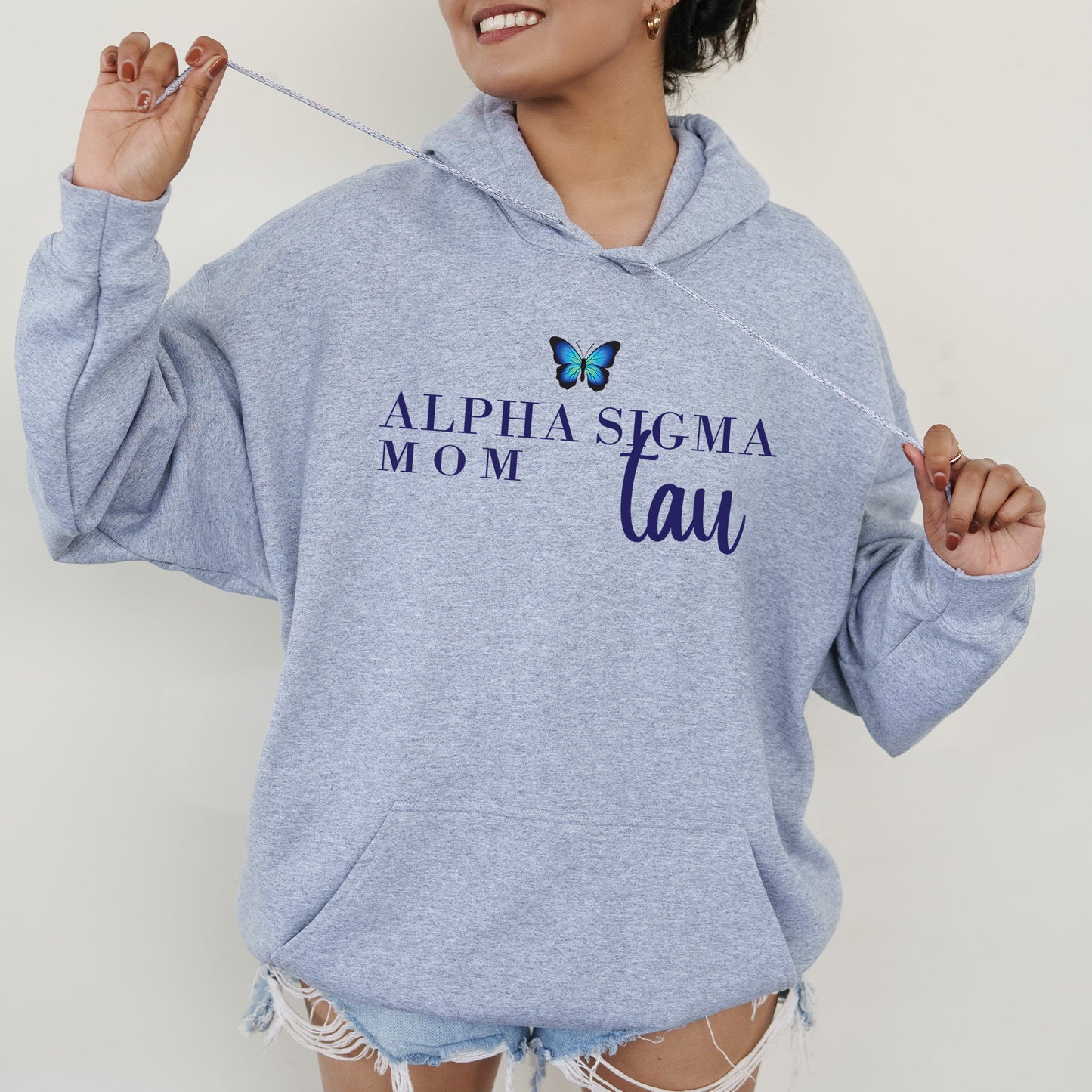 a woman wearing a blue sweatshirt with a butterfly on it