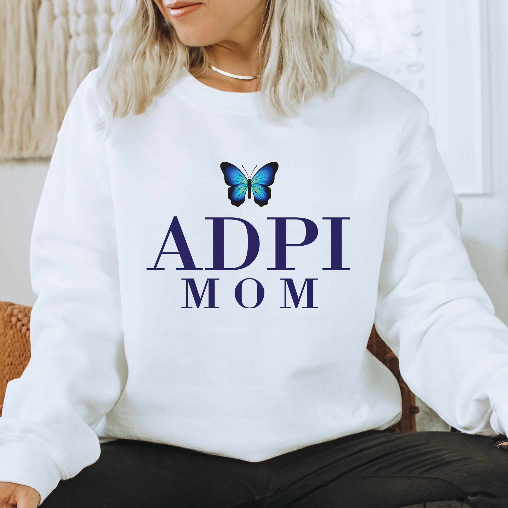 a woman wearing a sweatshirt with a butterfly on it