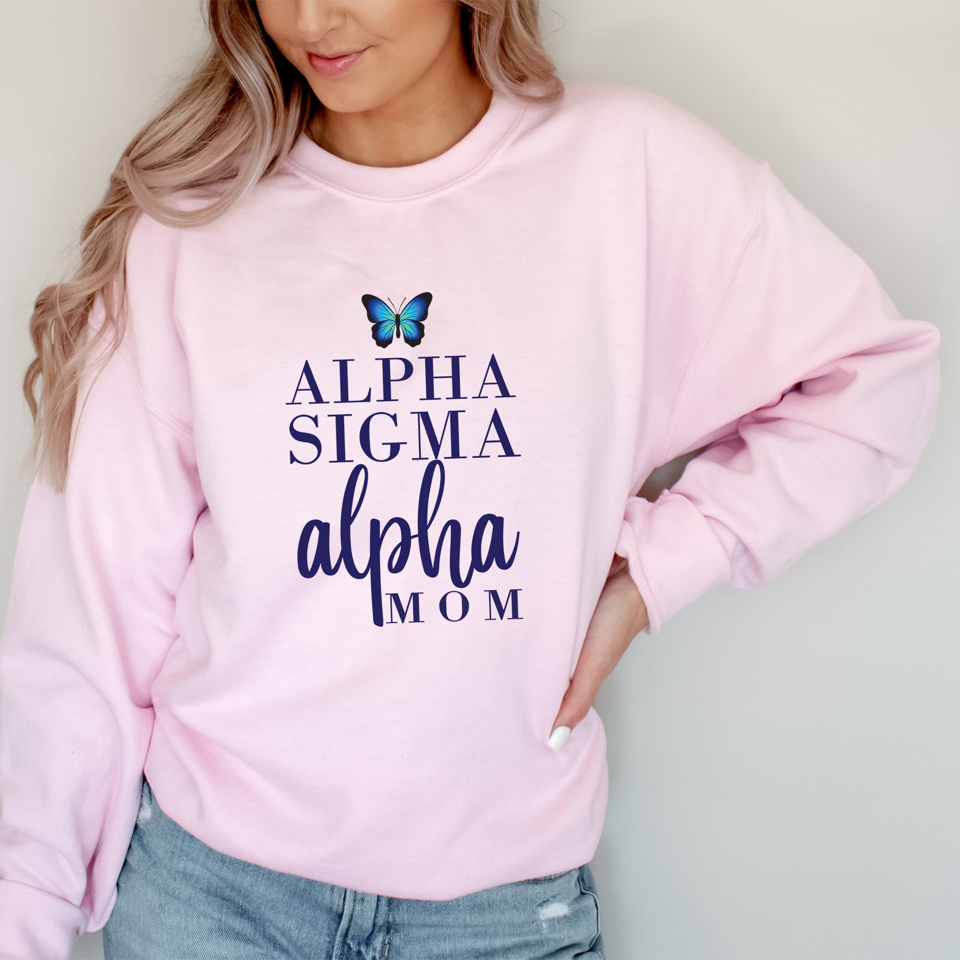 a woman wearing a pink sweatshirt with a butterfly on it