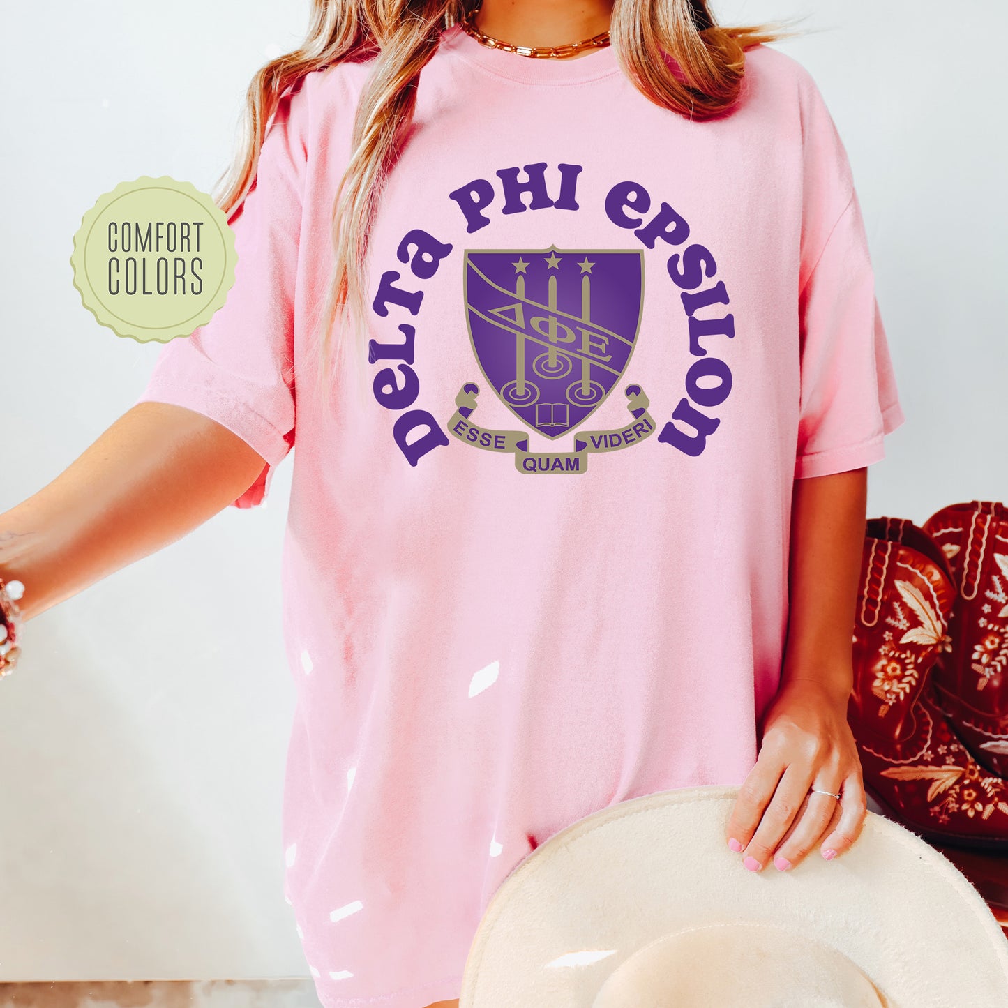 a woman wearing a pink shirt and hat