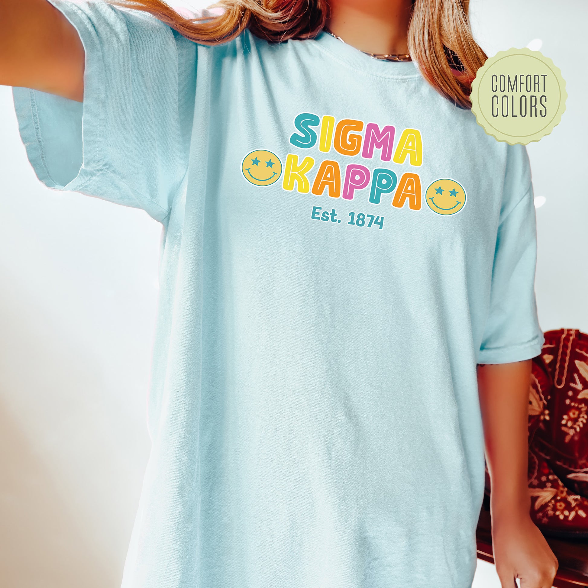 a woman wearing a t - shirt that says sigma kappa