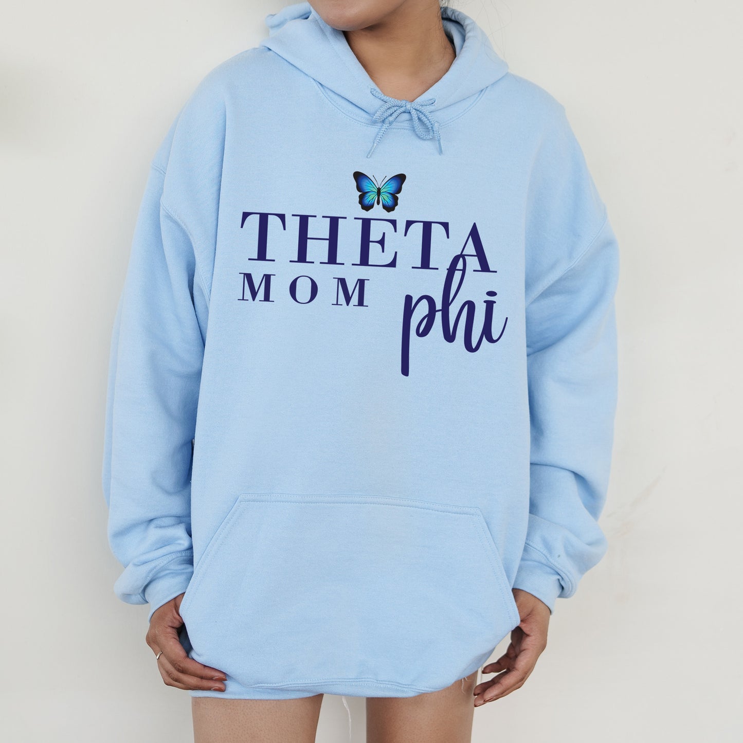 a woman wearing a blue hoodie with a butterfly on it