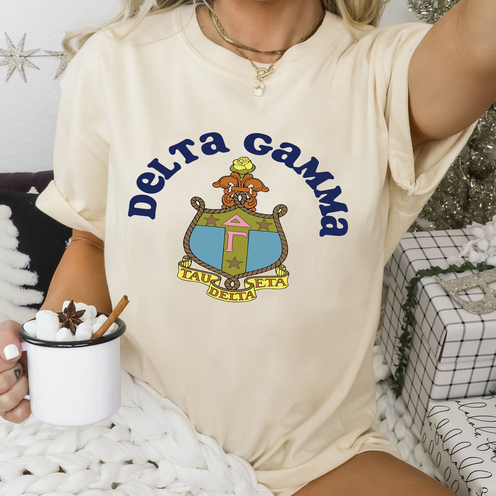 a woman sitting on a bed holding a cup of coffee