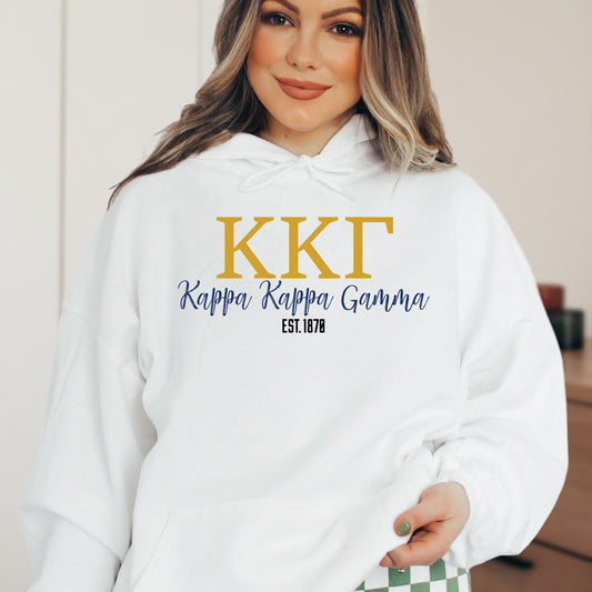 a woman wearing a white hoodie with the kkt logo on it