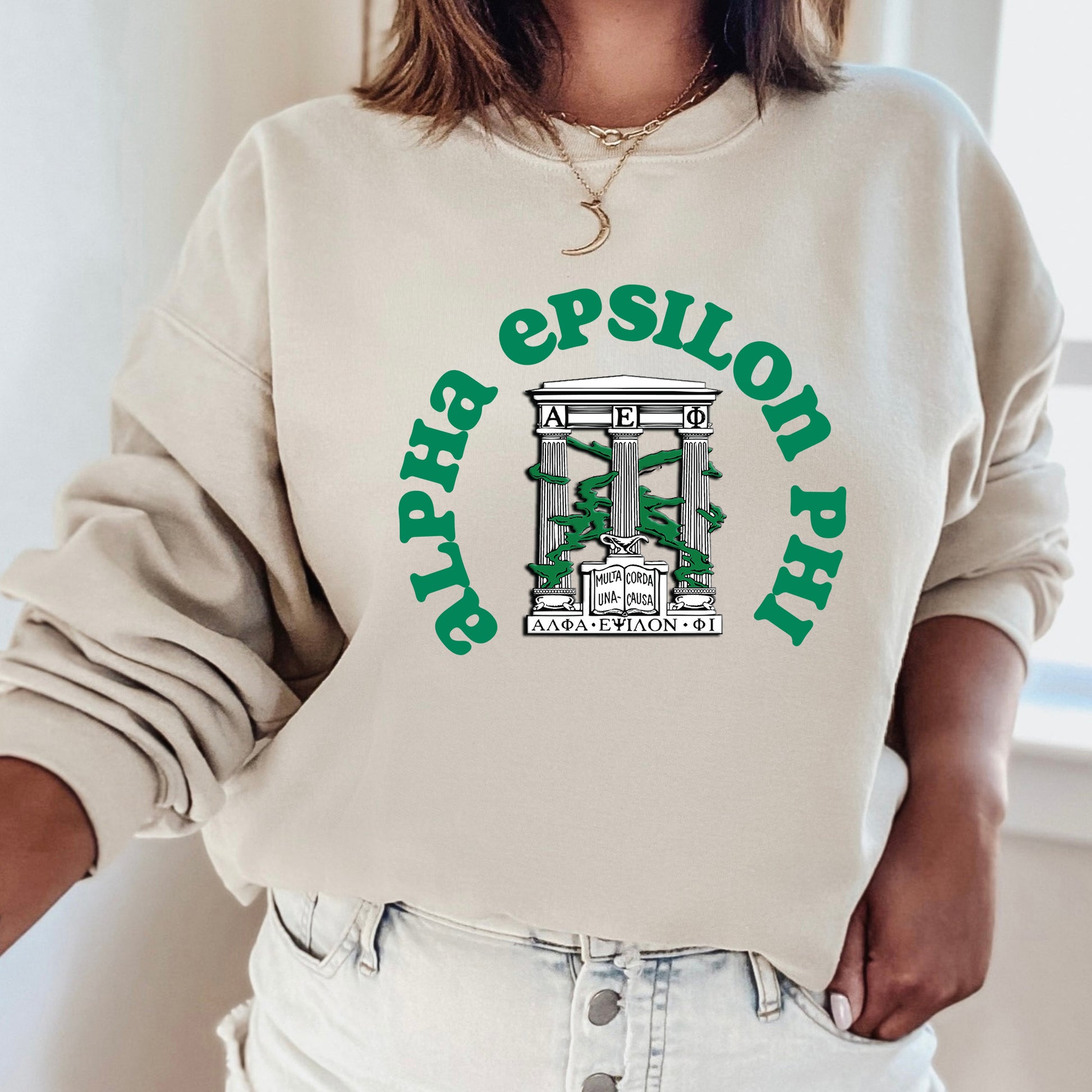 a woman wearing a sweatshirt with a green logo on it