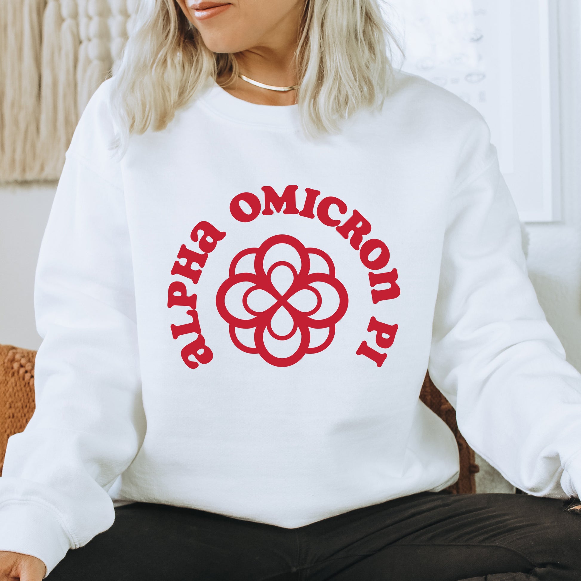 a woman sitting on a chair wearing a white sweatshirt