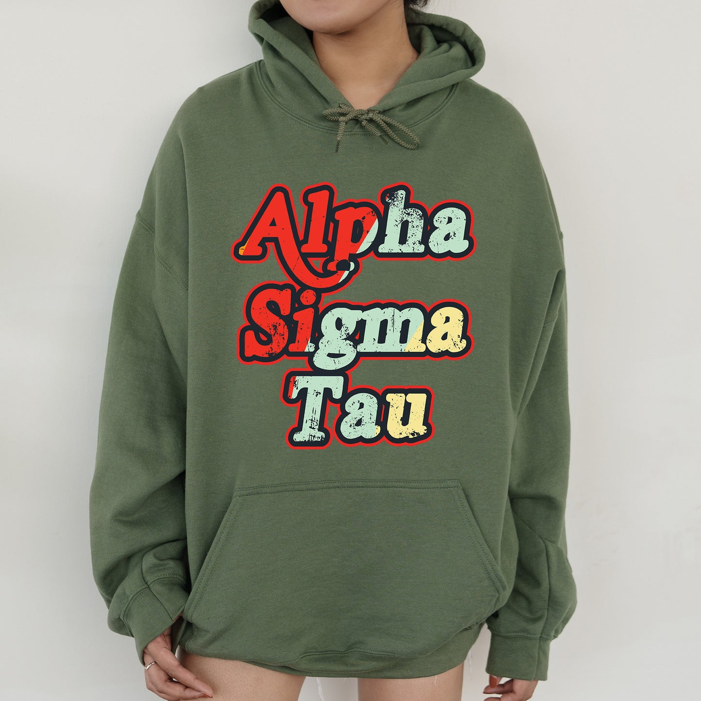 a woman wearing a green hoodie that says aloha stigma tau