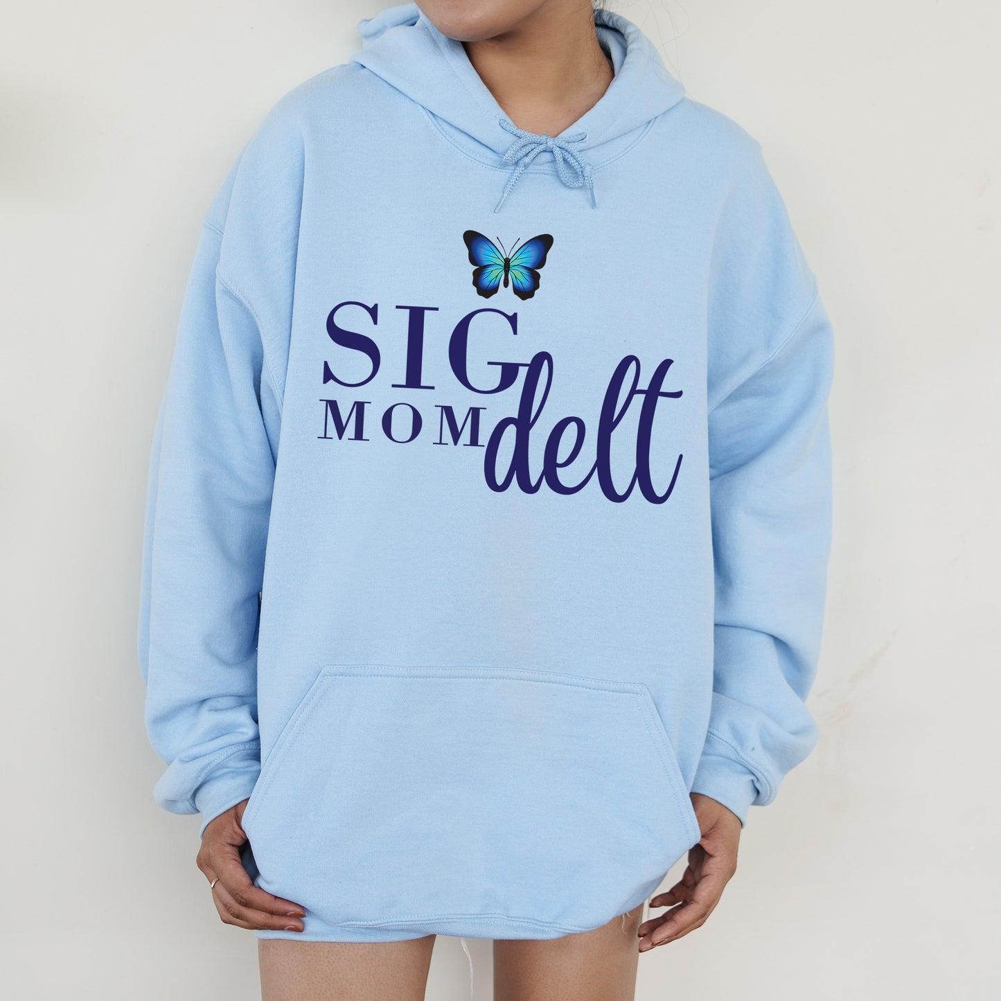 a woman wearing a blue hoodie with a butterfly on it