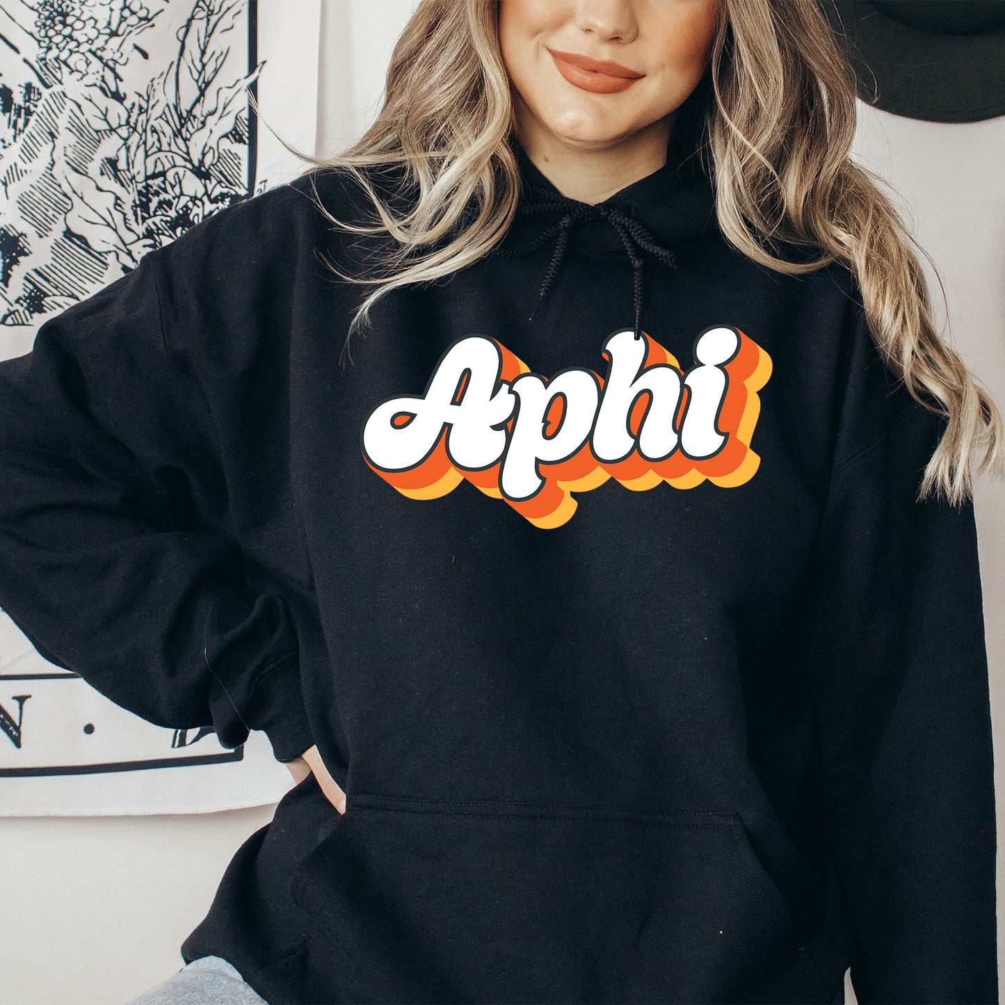 a woman wearing a black hoodie with the word apphi on it