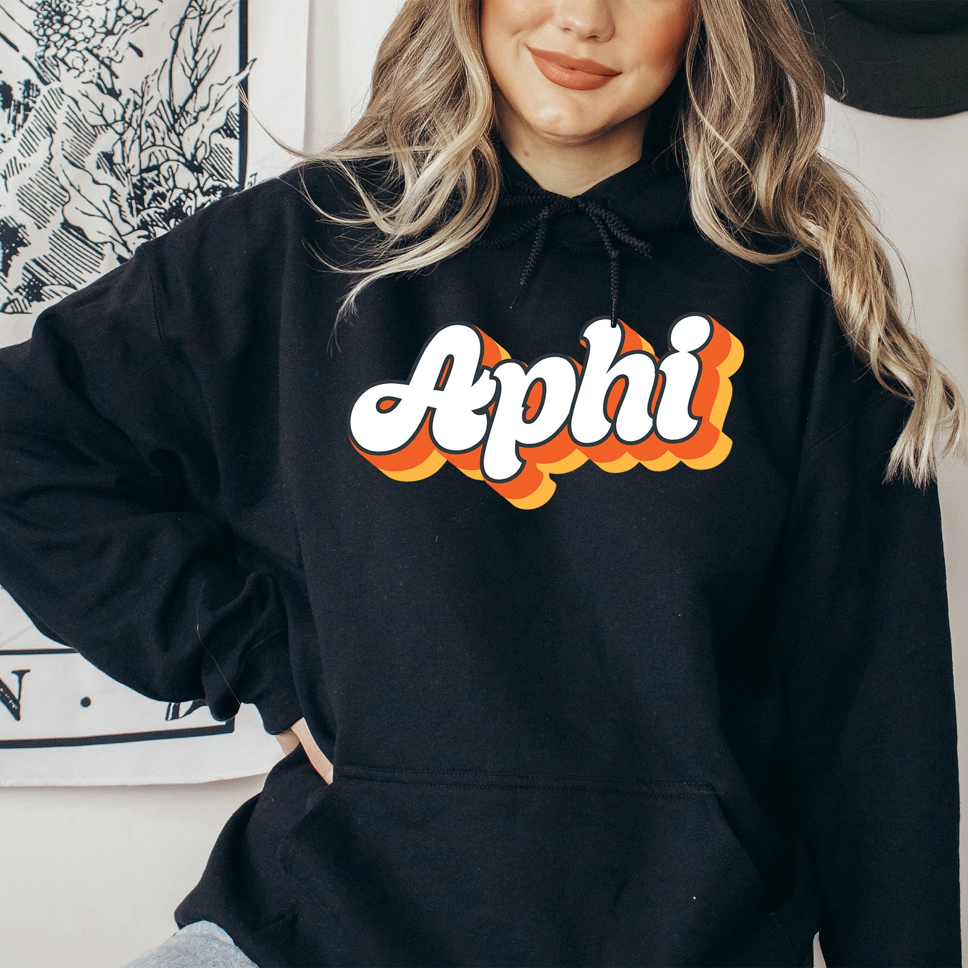 a woman wearing a black hoodie with the word apphi on it
