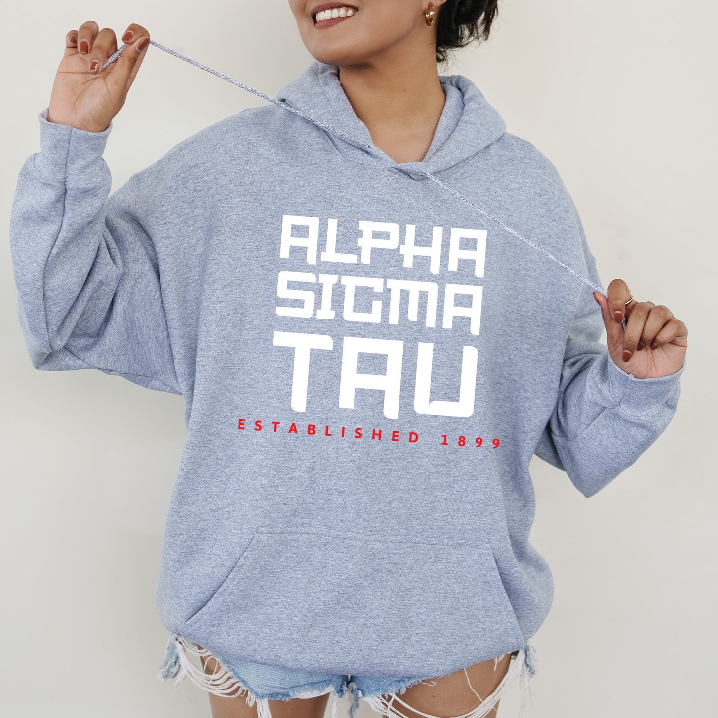 a woman in a blue hoodie is holding a toothbrush
