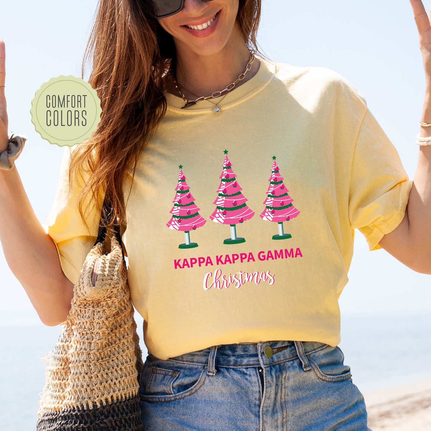 a woman wearing a yellow shirt with pink trees on it