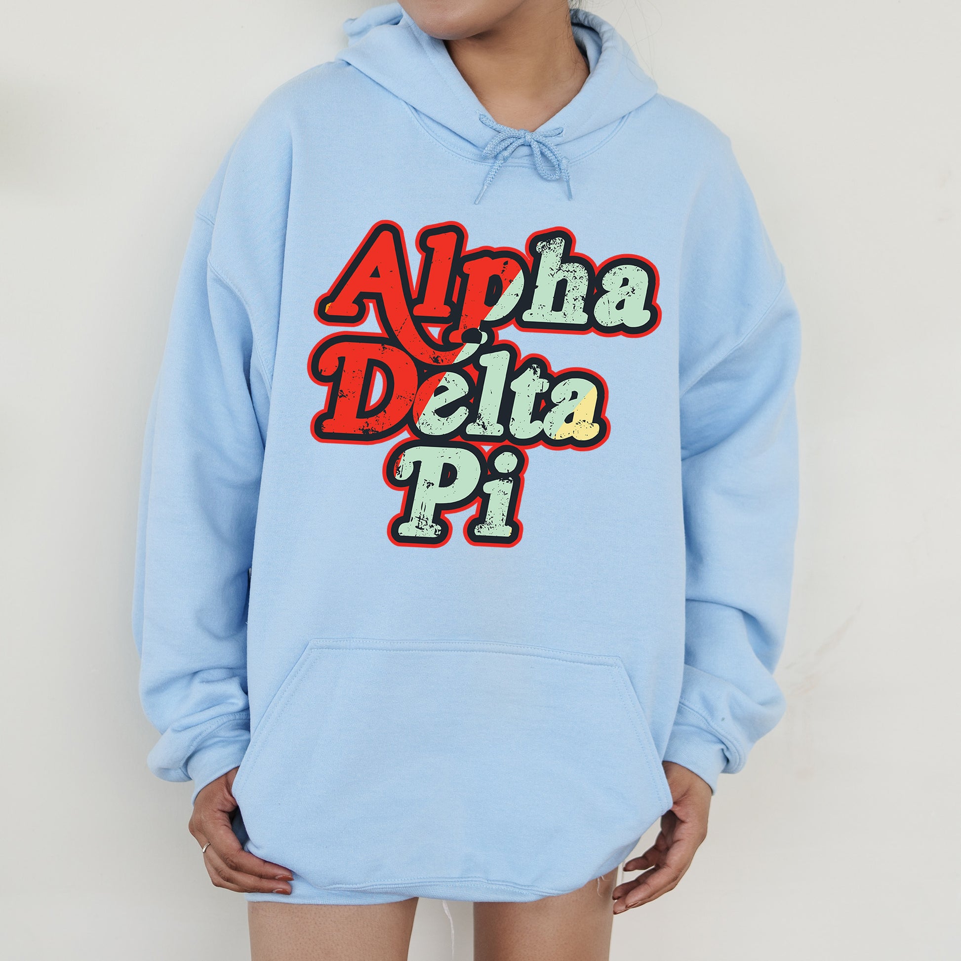 a person wearing a blue hoodie with the words aloh delta pi on it