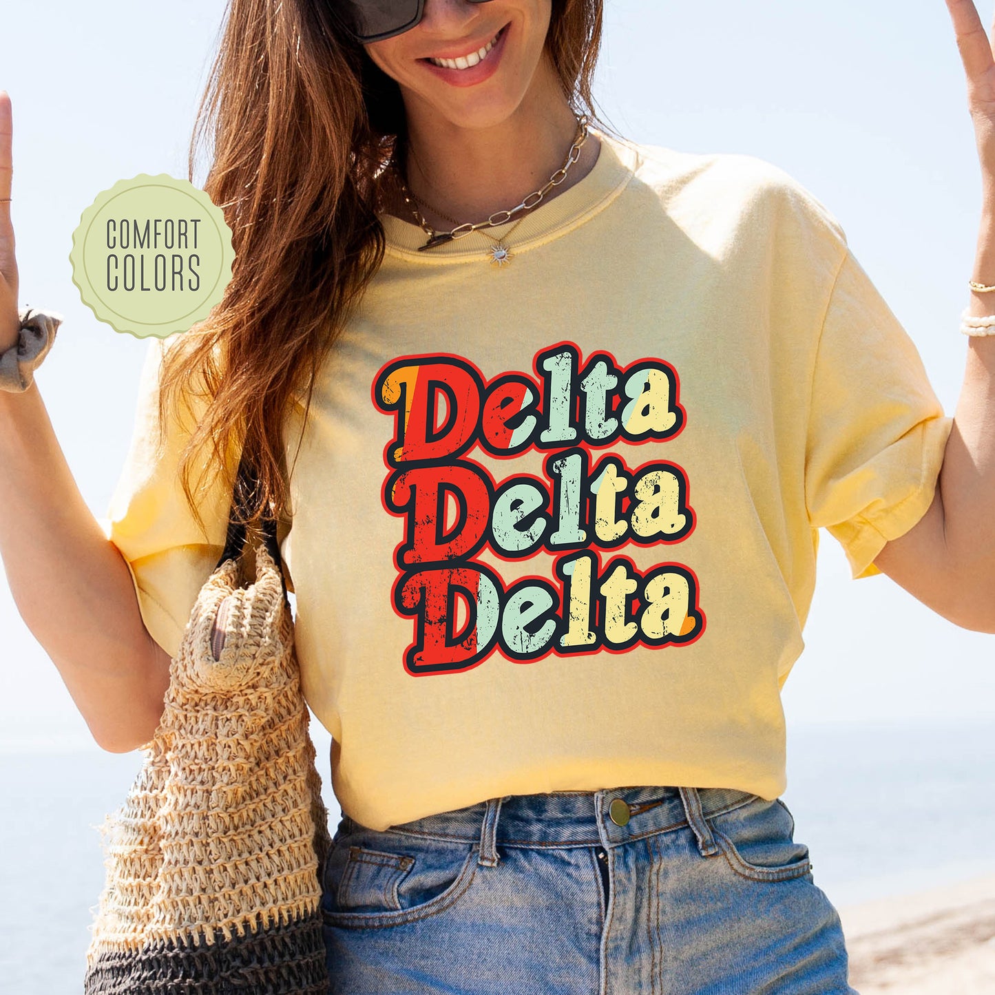 a woman wearing a yellow shirt with the words delta delta written on it