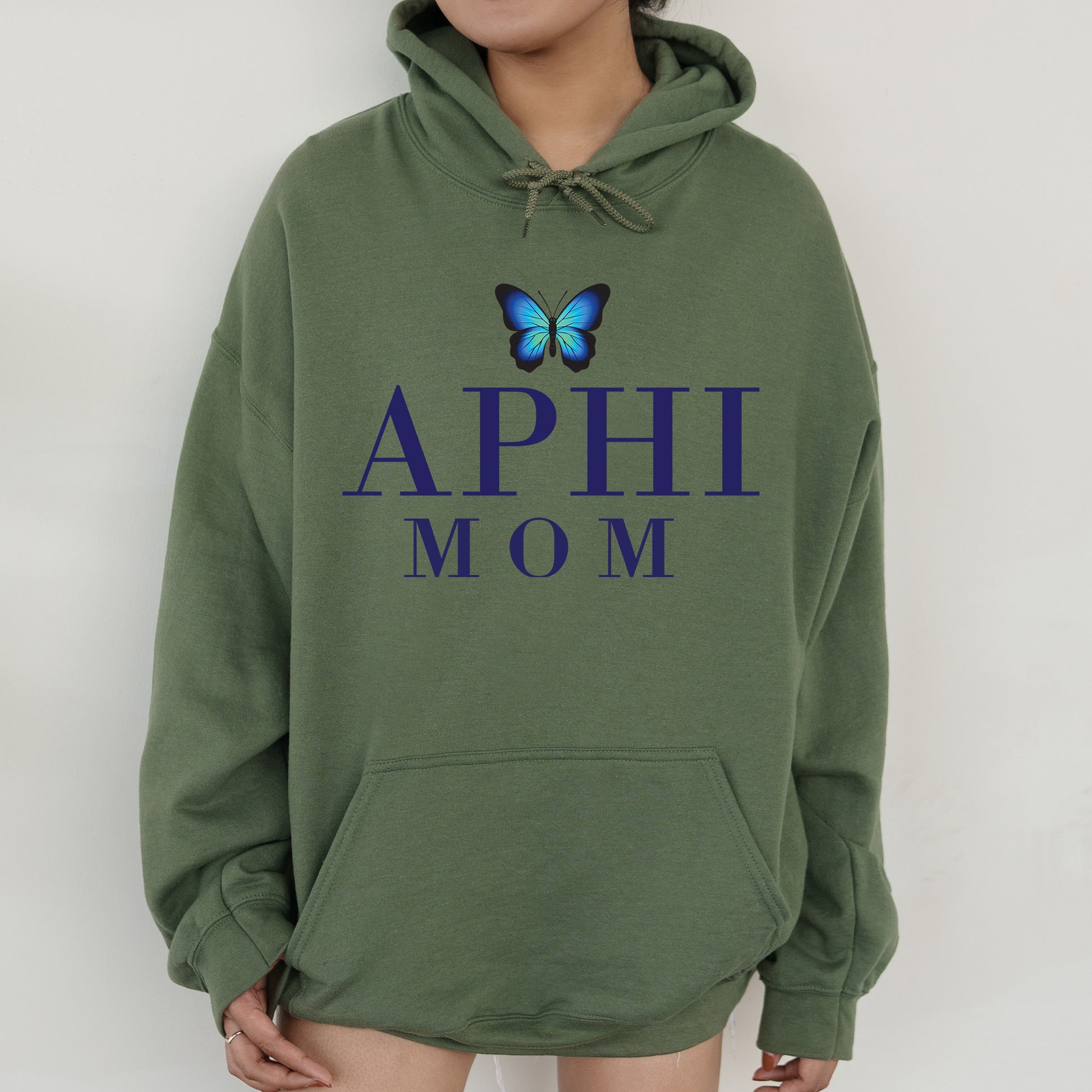 a woman wearing a green hoodie with a blue butterfly on it