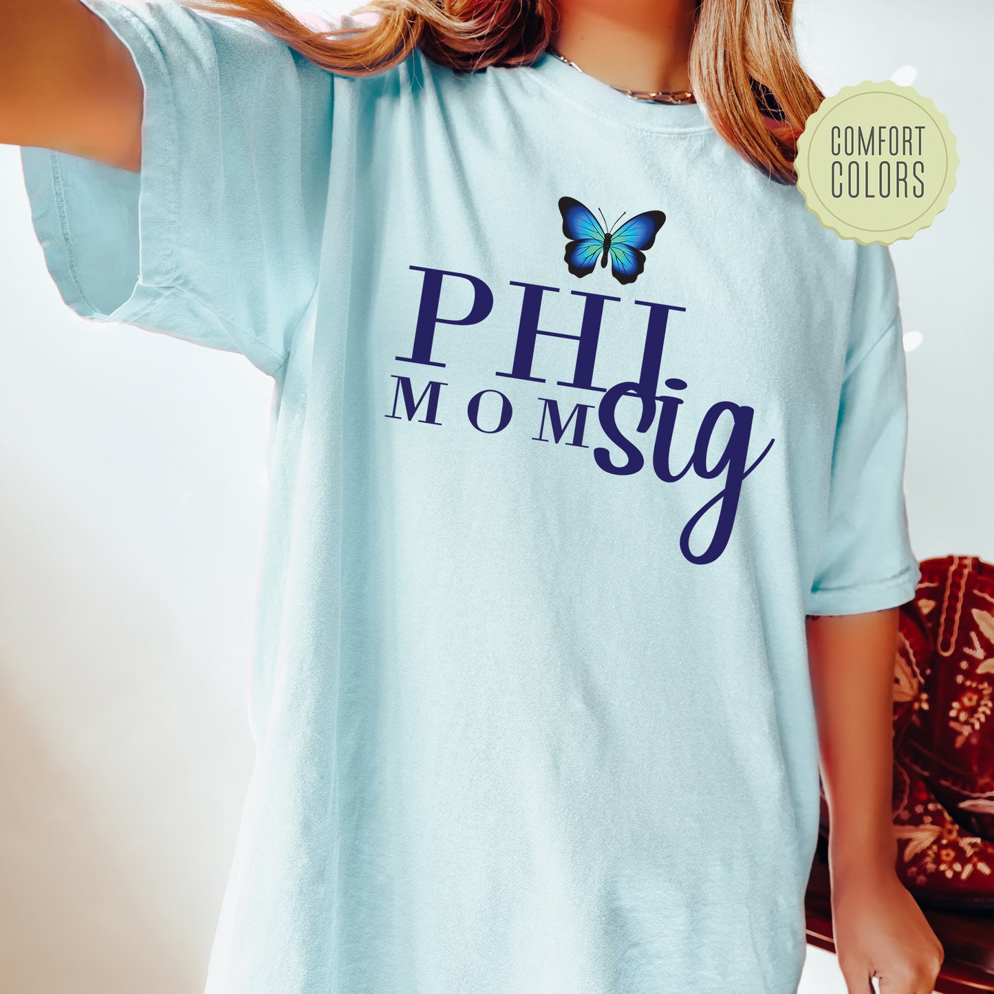 a girl wearing a blue shirt with a butterfly on it