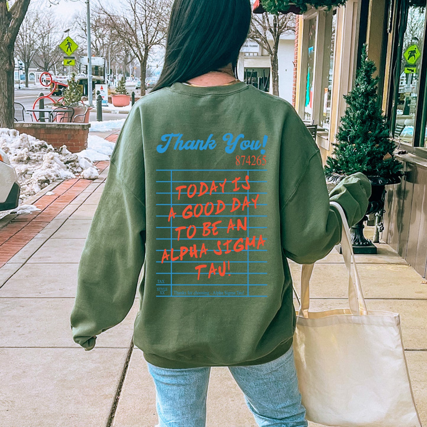 a woman walking down a sidewalk carrying a bag