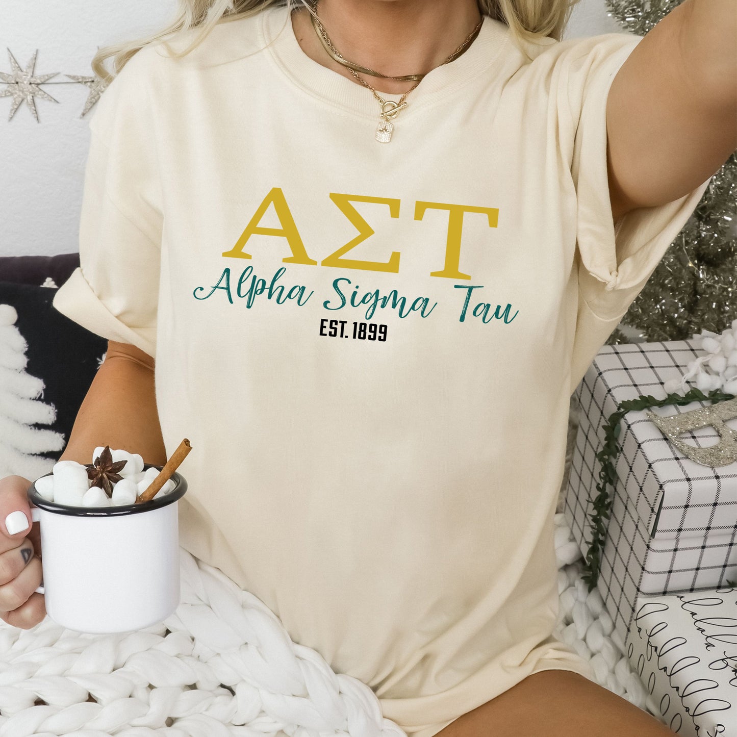 a woman sitting on a bed holding a cup of coffee