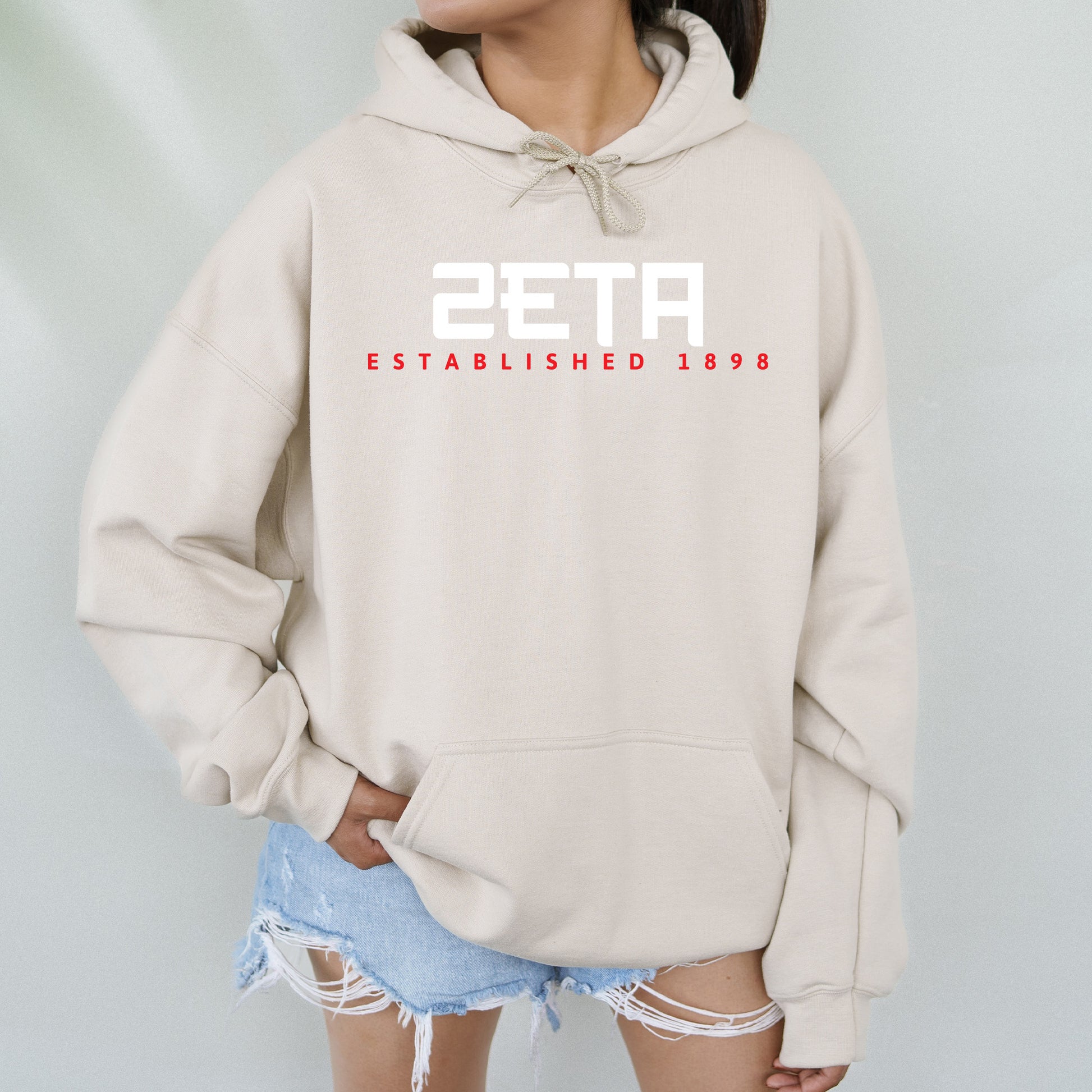 a woman wearing a hoodie with the number twenty seven printed on it