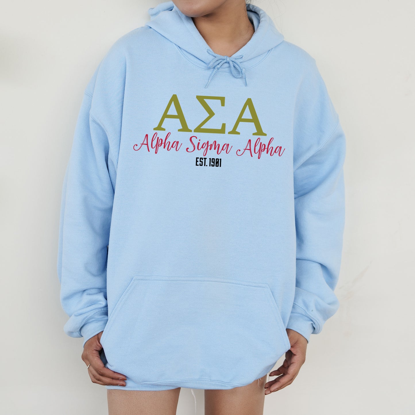 a person wearing a blue hoodie with the letters aza on it