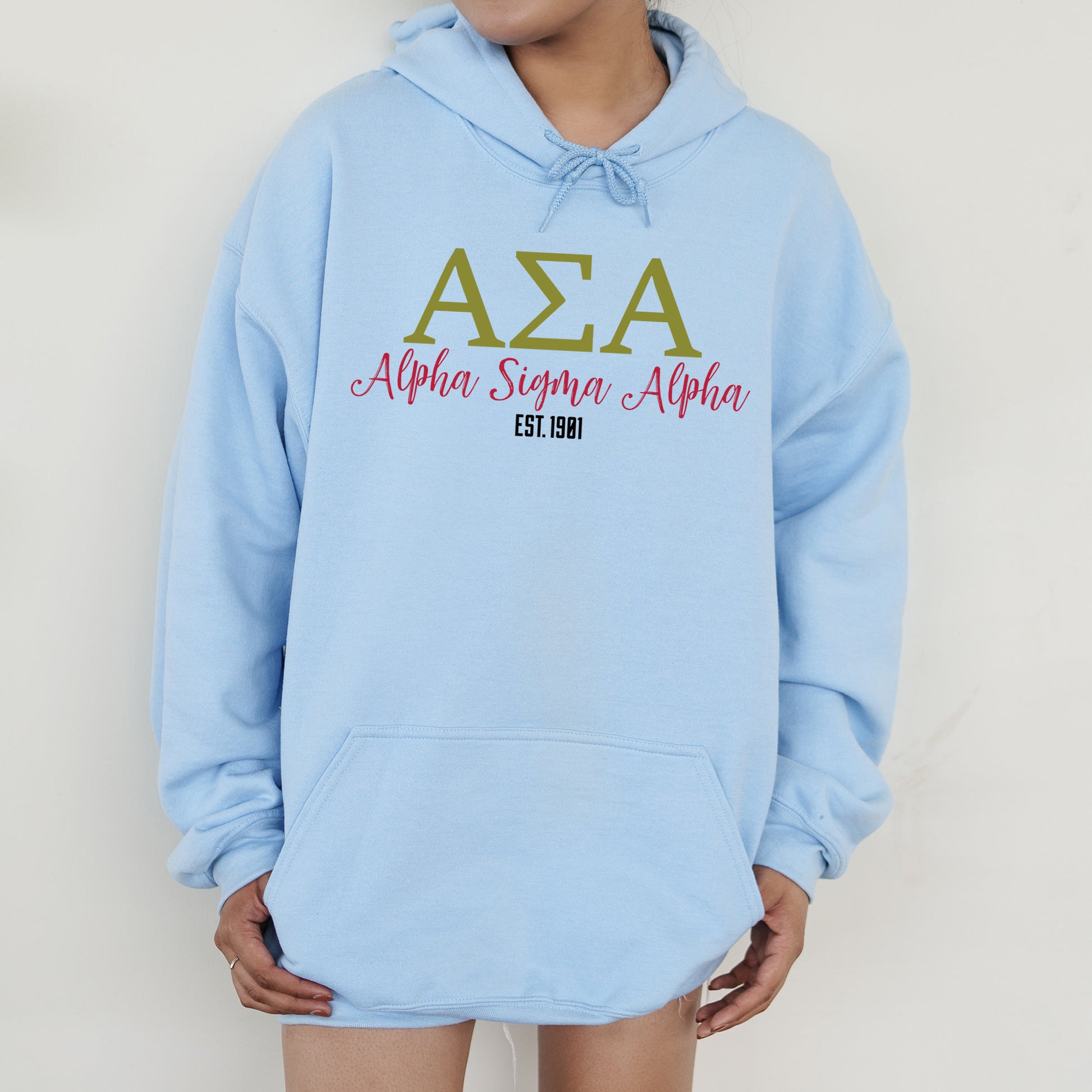 a person wearing a blue hoodie with the letters aza on it