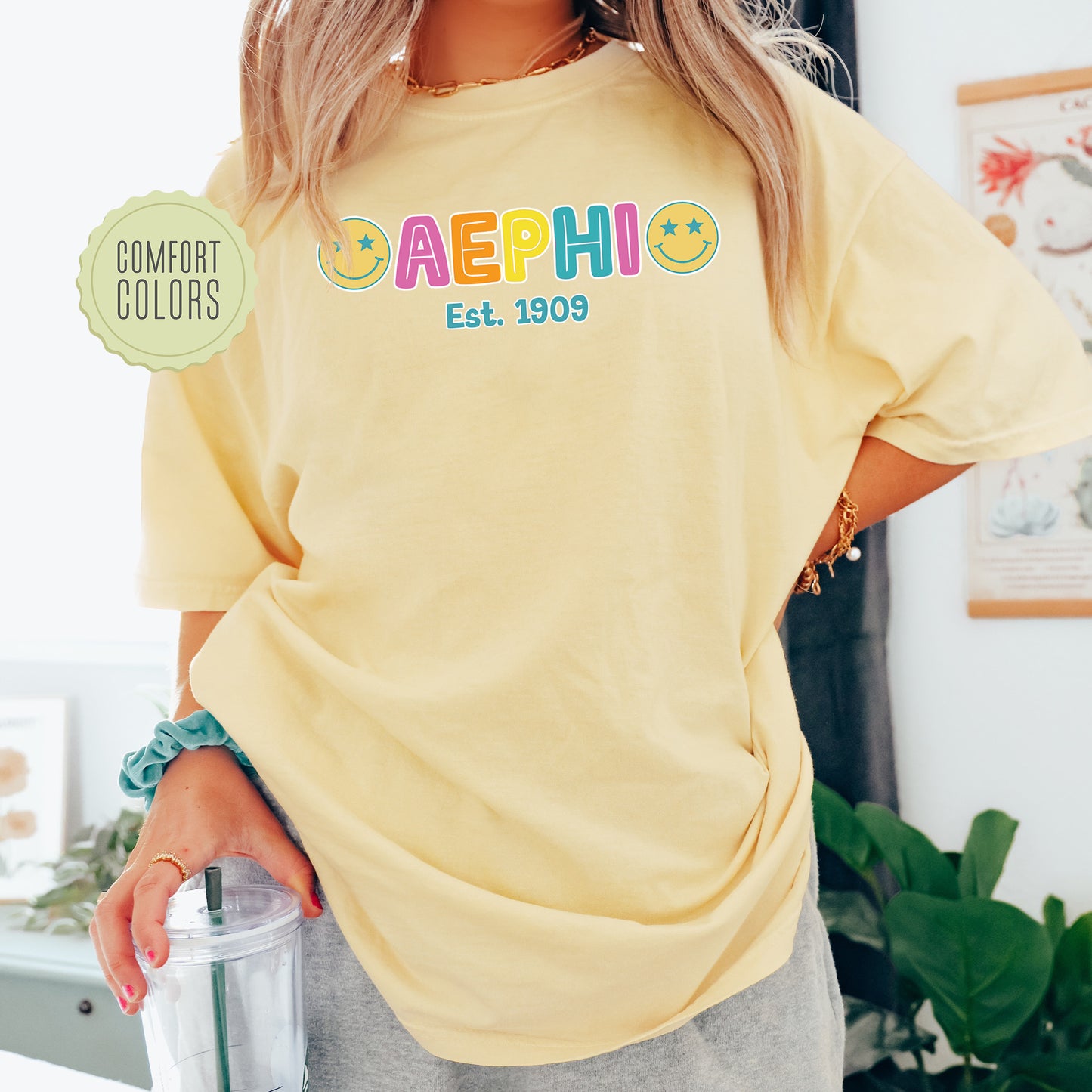 a woman in a yellow shirt holding a blender