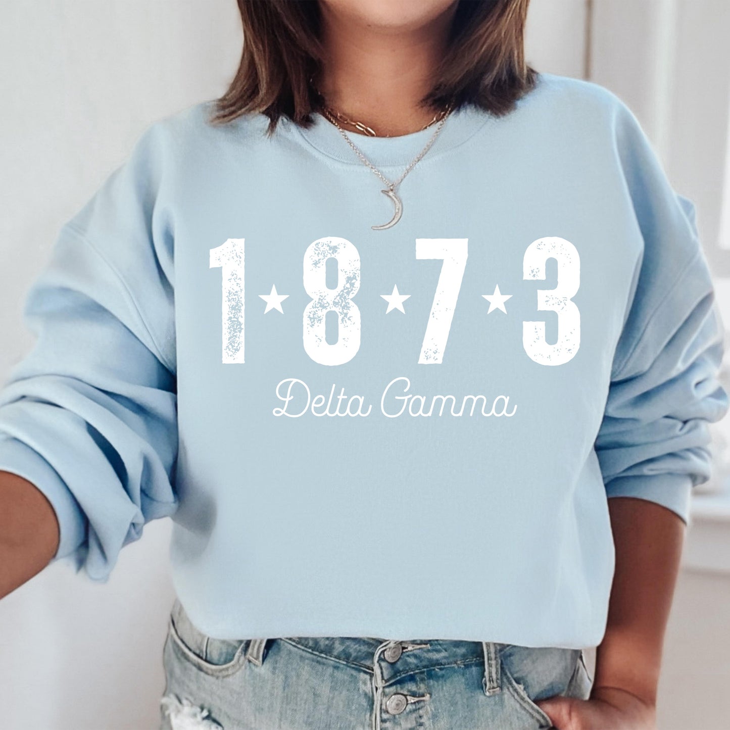 a woman wearing a blue sweatshirt with white lettering