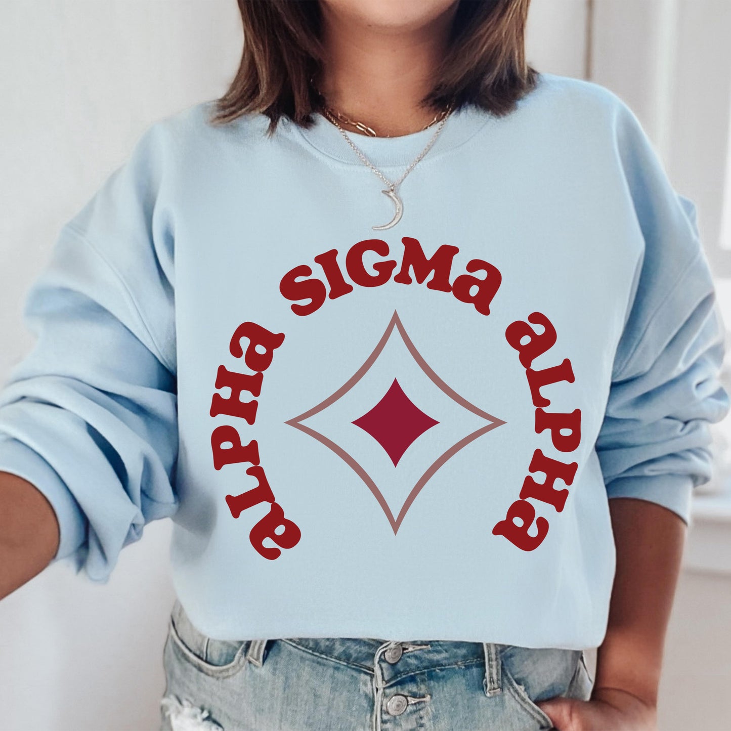 a woman wearing a blue sweatshirt with a red and white sign on it