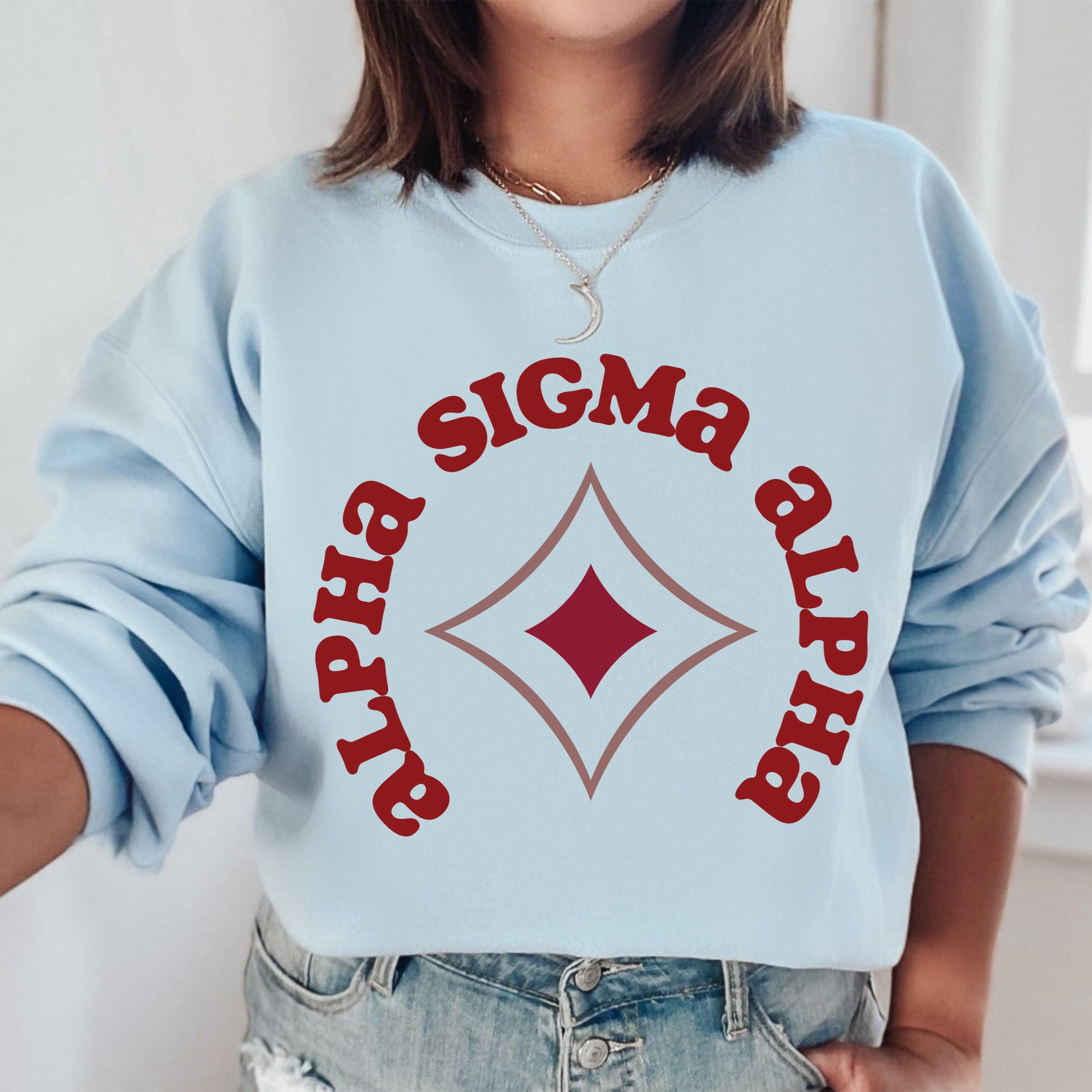 a woman wearing a blue sweatshirt with a red and white sign on it