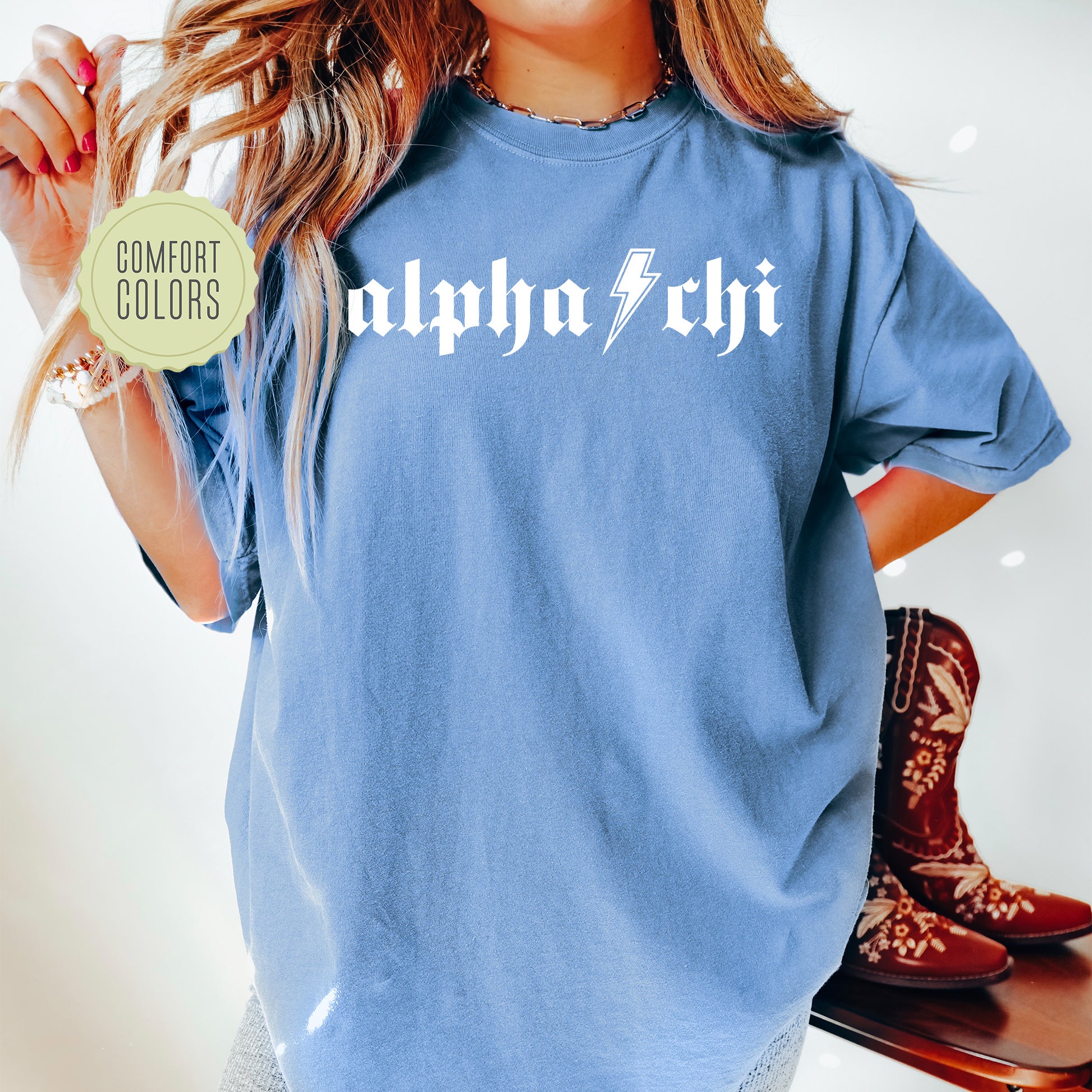 a woman in a blue shirt holding a skateboard