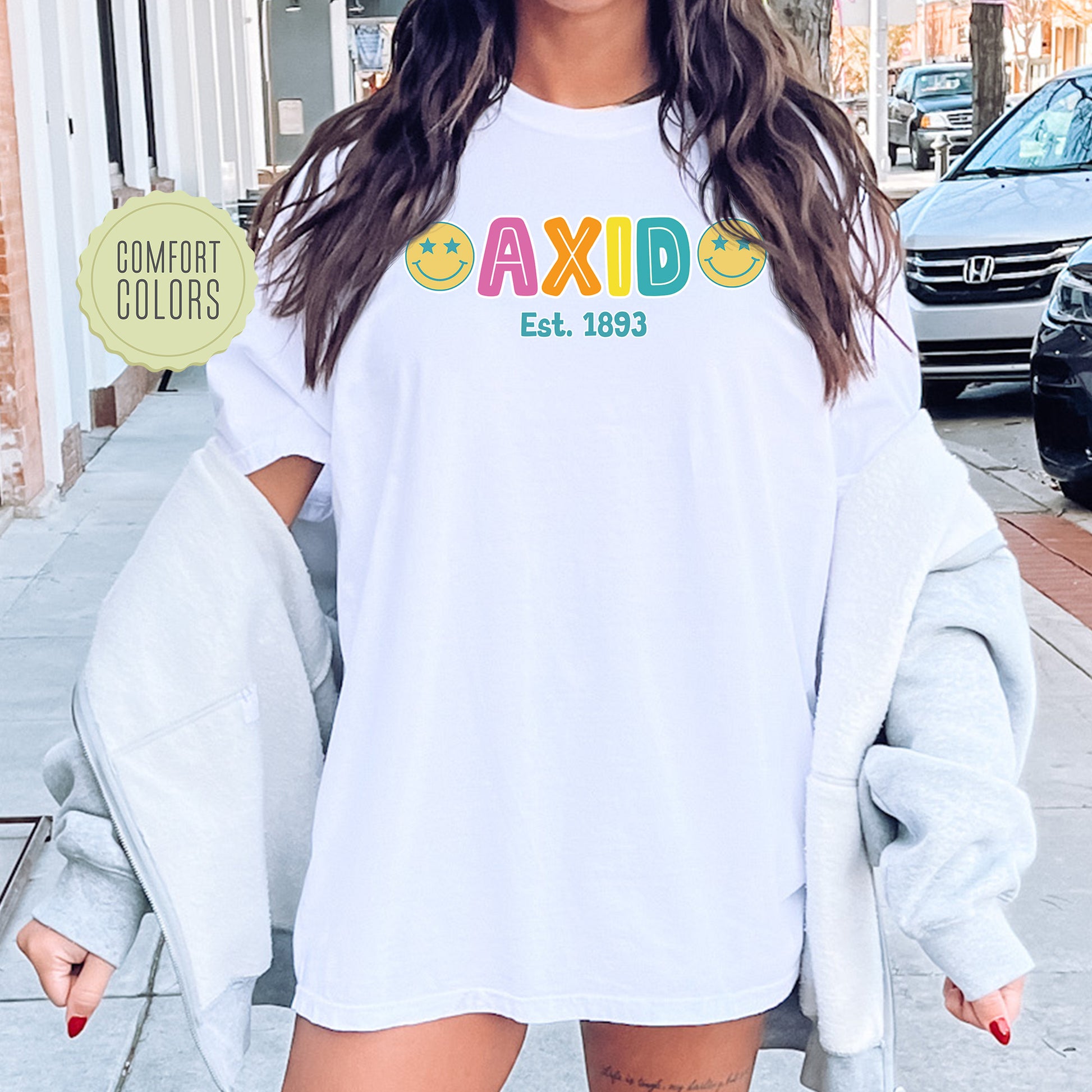 a woman wearing a white shirt with the word axid on it