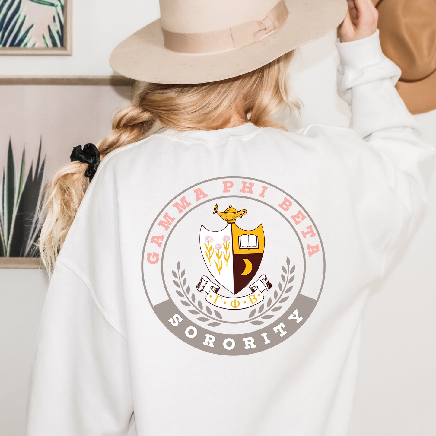 a woman wearing a white sweatshirt and a hat