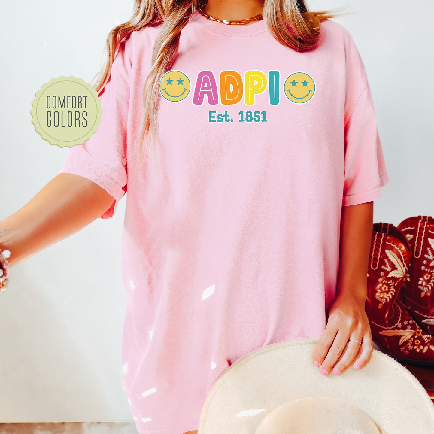 a woman wearing a pink shirt and hat