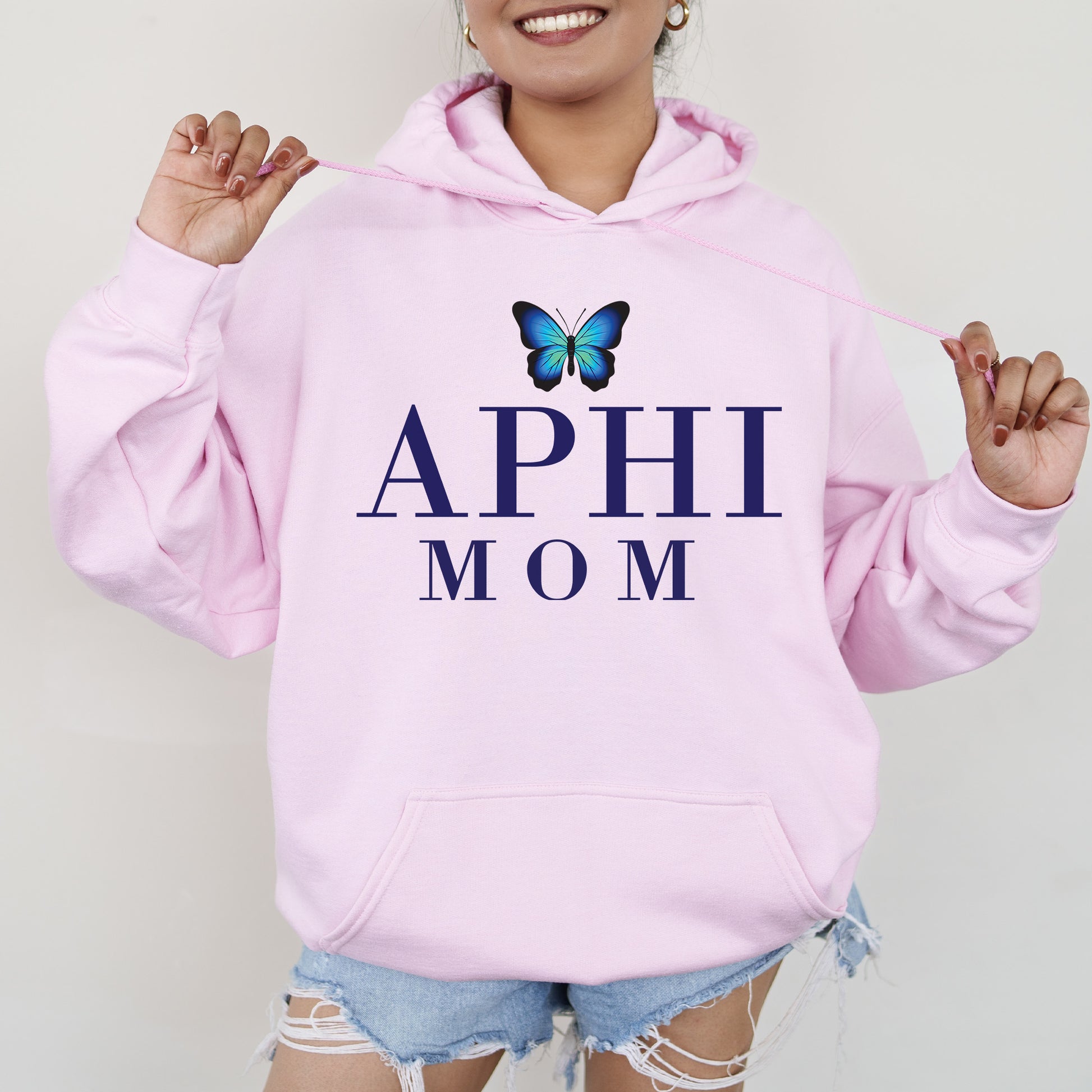 a woman wearing a pink hoodie with a butterfly on it