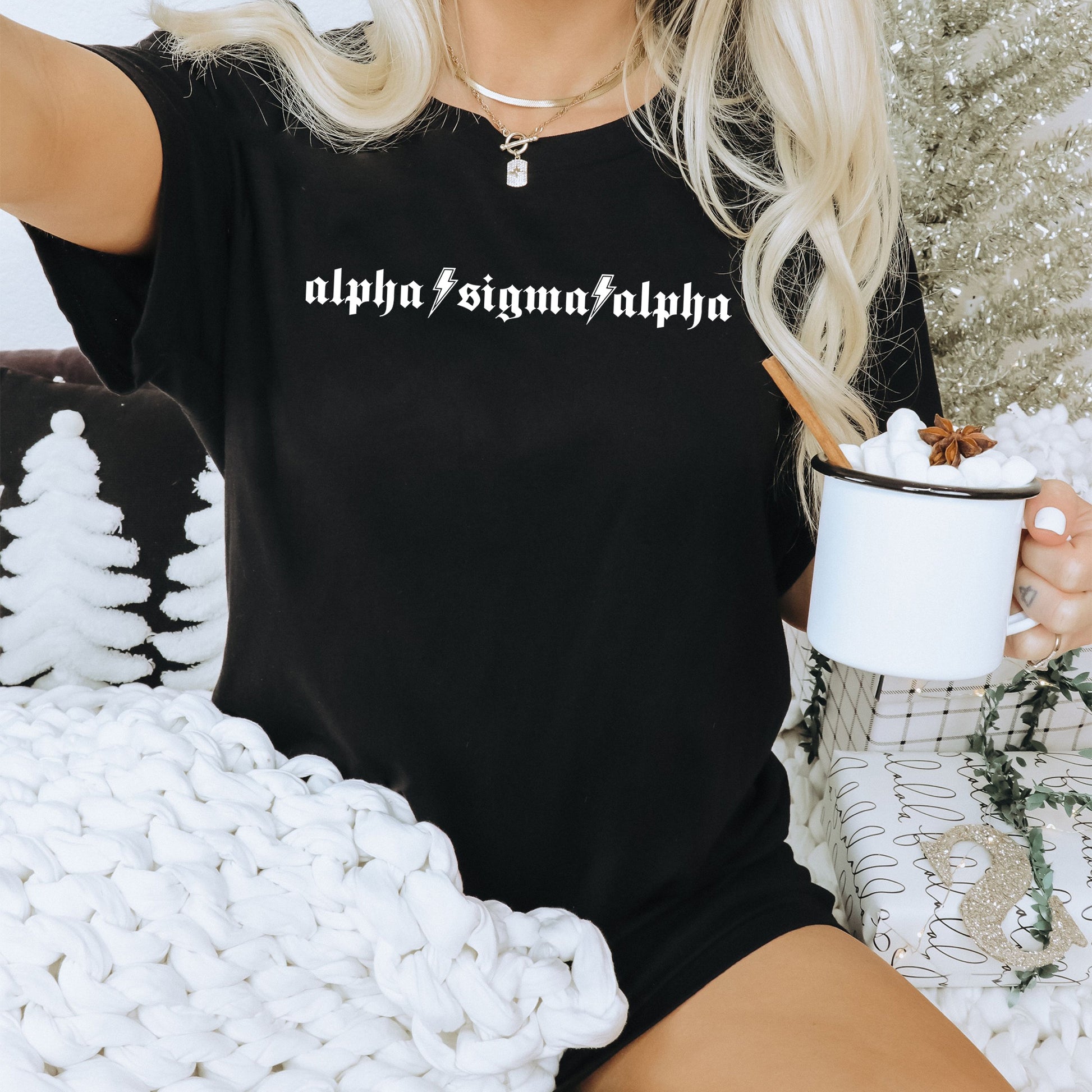 a woman sitting on a couch holding a cup of coffee