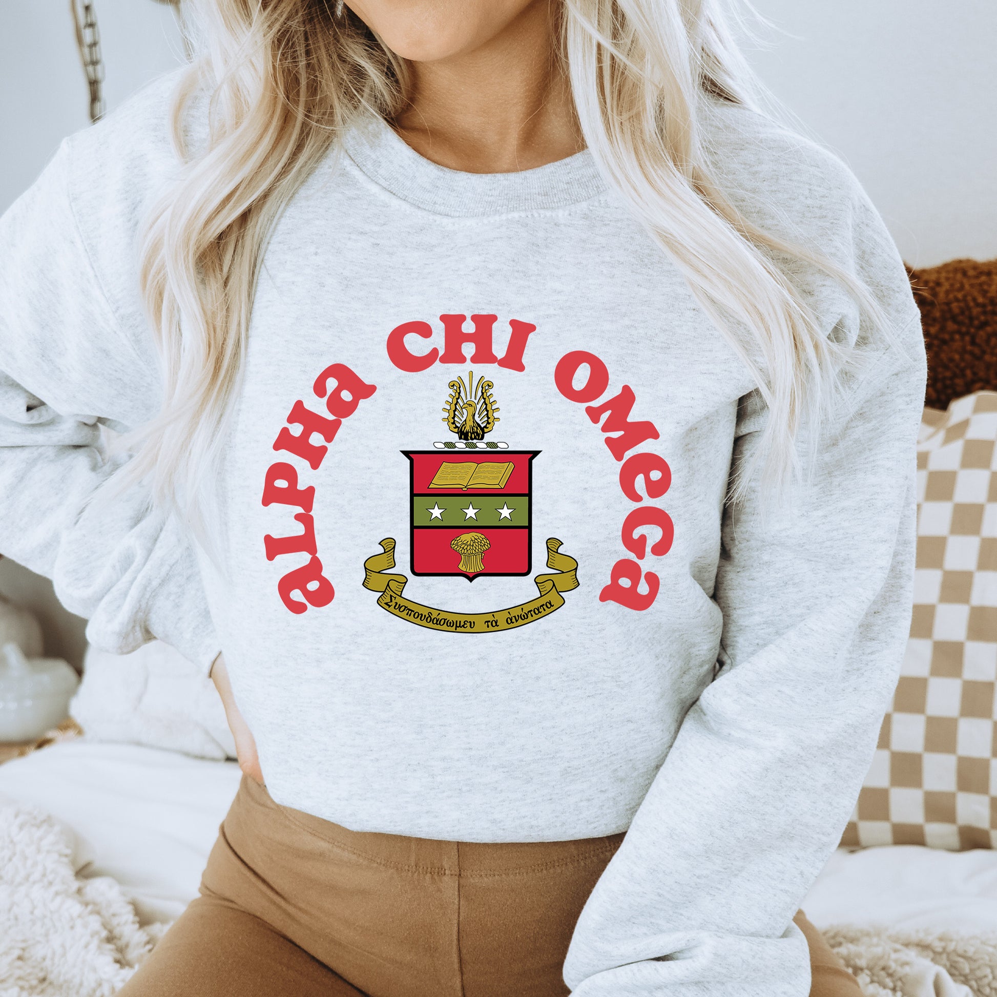 a woman wearing a sweatshirt with a crest on it