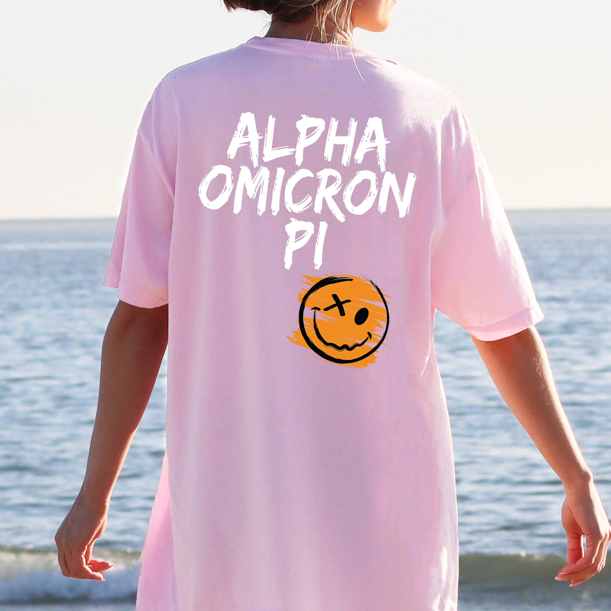 a person wearing a pink shirt with a smiley face on it