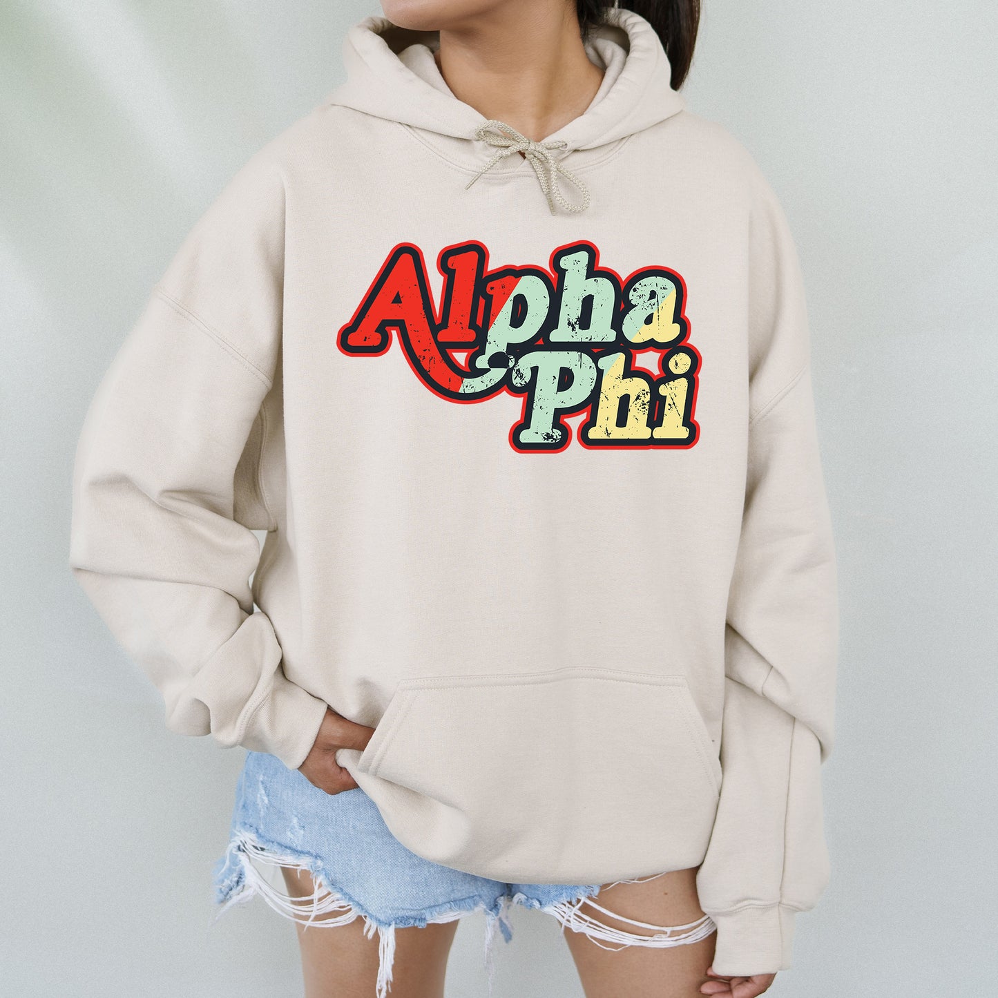 a woman wearing a white sweatshirt with the word apha pm on it