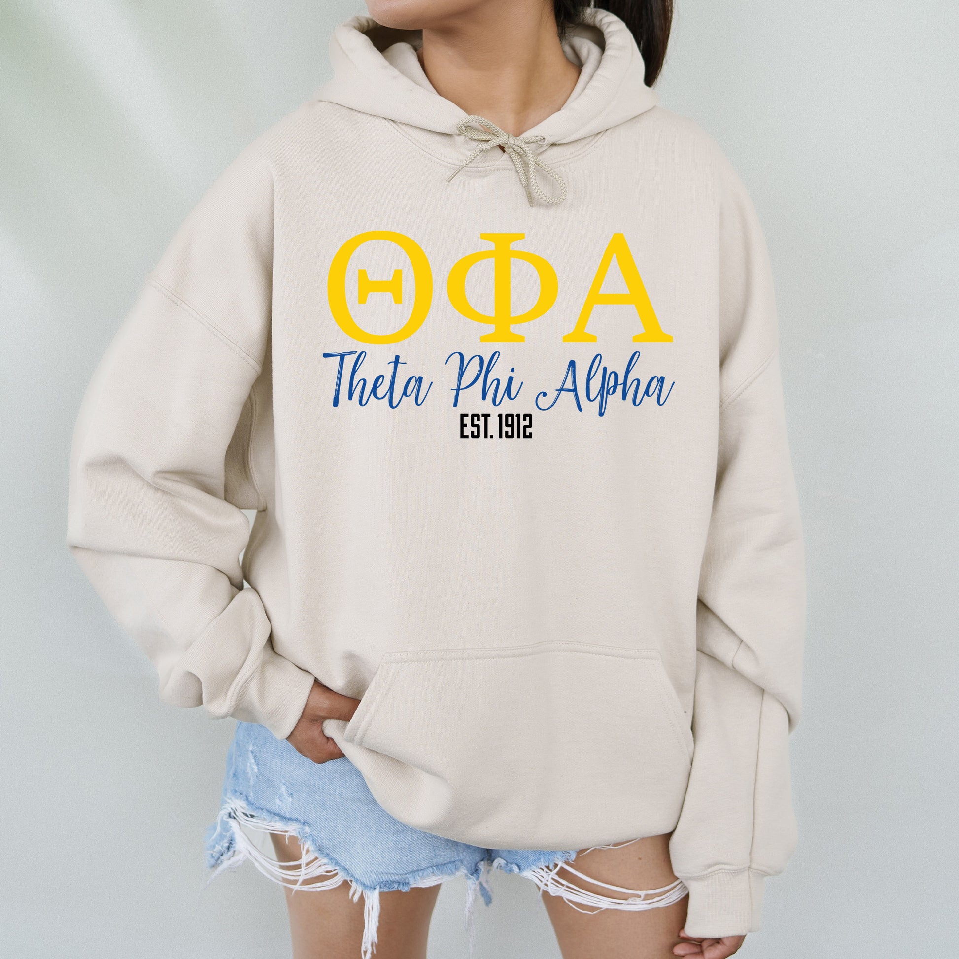 a woman wearing a sweatshirt with the letters phi and phi on it