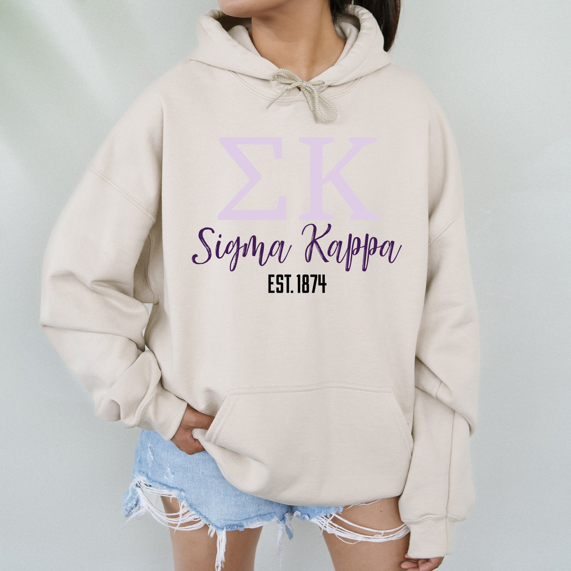 a woman wearing a white hoodie with a purple and blue design on it