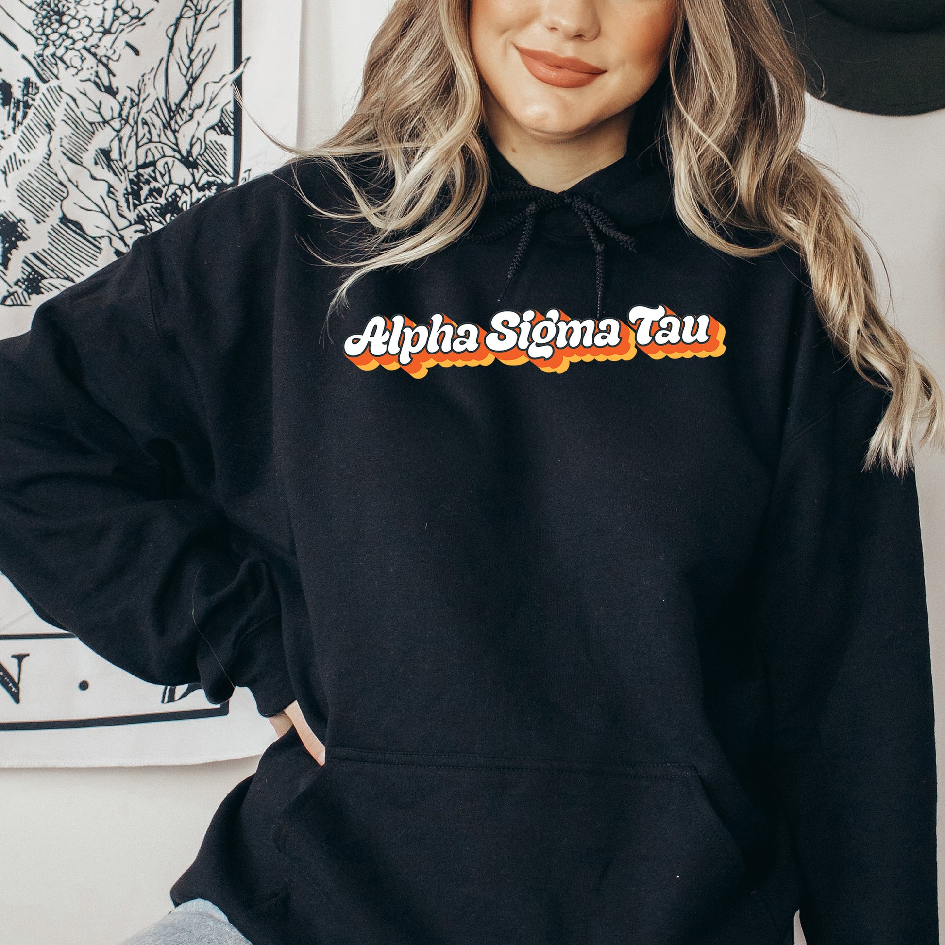 a woman wearing a black hoodie with the words aloha slima tau