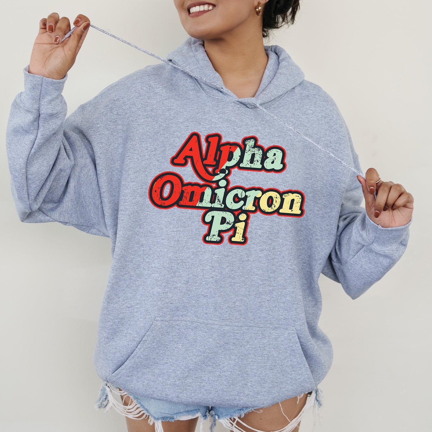 a woman in a blue hoodie is holding a toothbrush